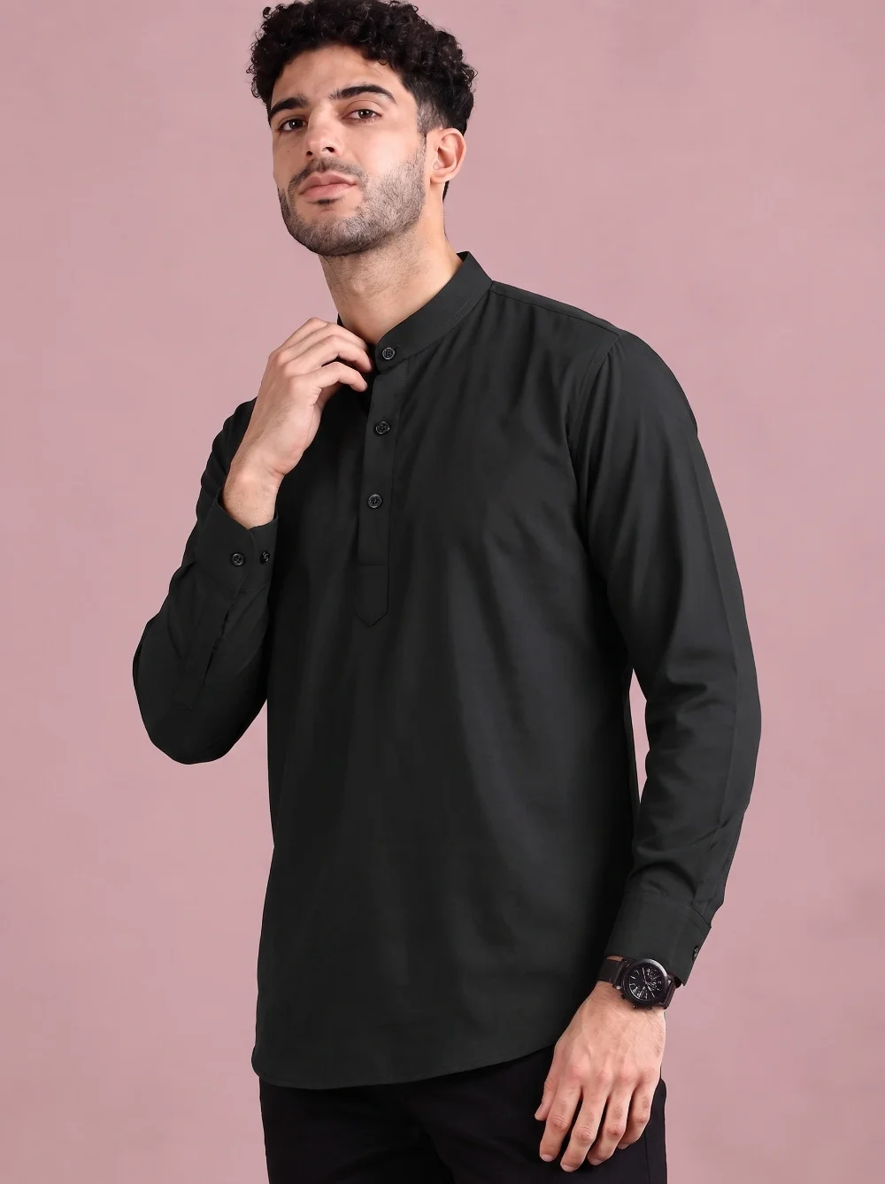 Black kurta, long sleeves, mandarin collar, front buttons. Worn by a model