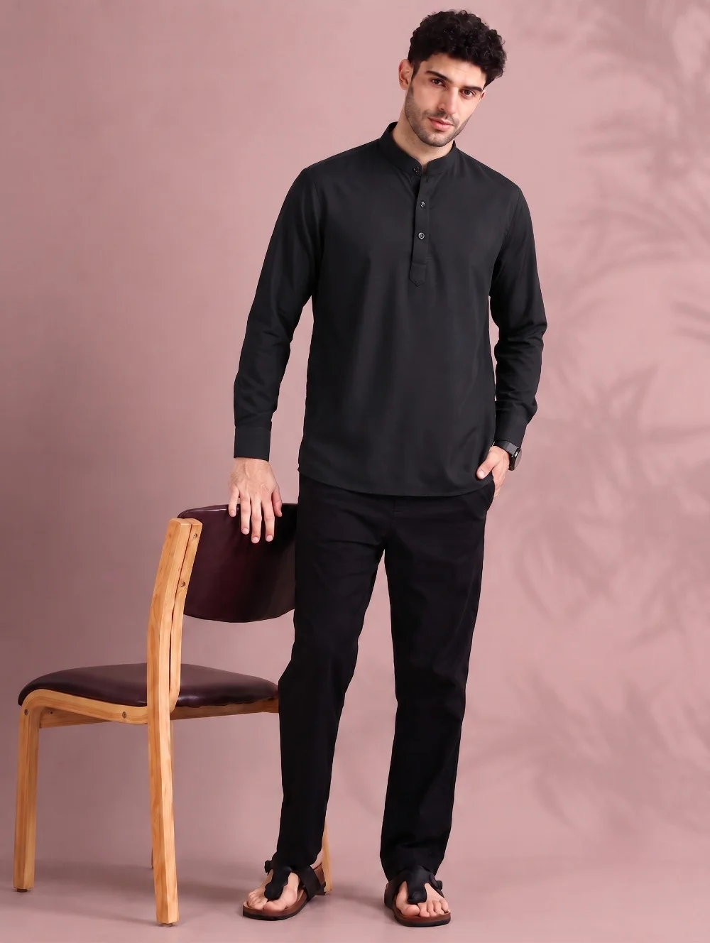 Black kurta, long sleeves, mandarin collar, buttons, worn by a model