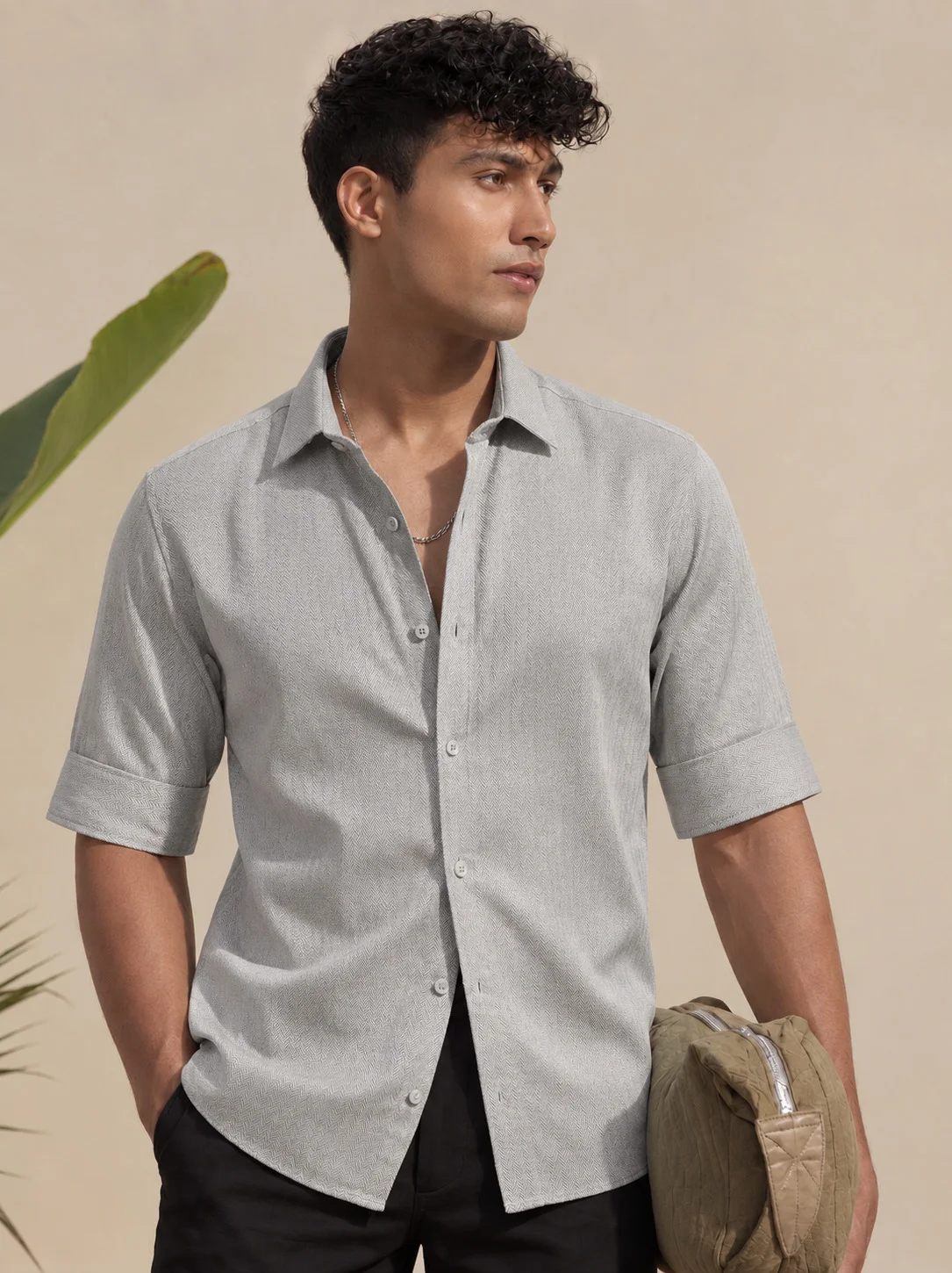 Taupe short-sleeve shirt worn by a model, front view with buttons, collar, and cuffed sleeves