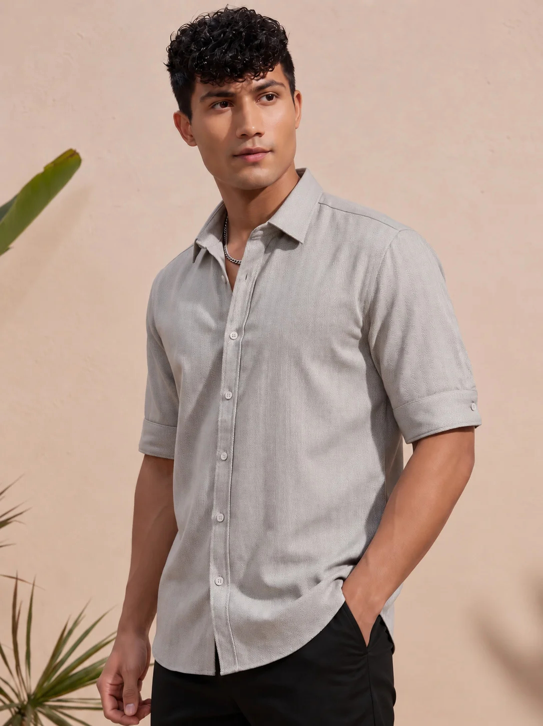 Model wearing taupe half-sleeve shirt with spread collar and front buttons