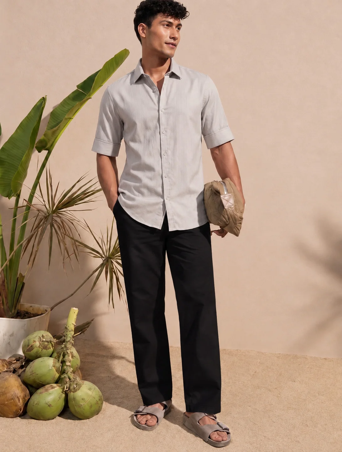 Light brown short-sleeved shirt, worn by a model, collar visible, buttons down front