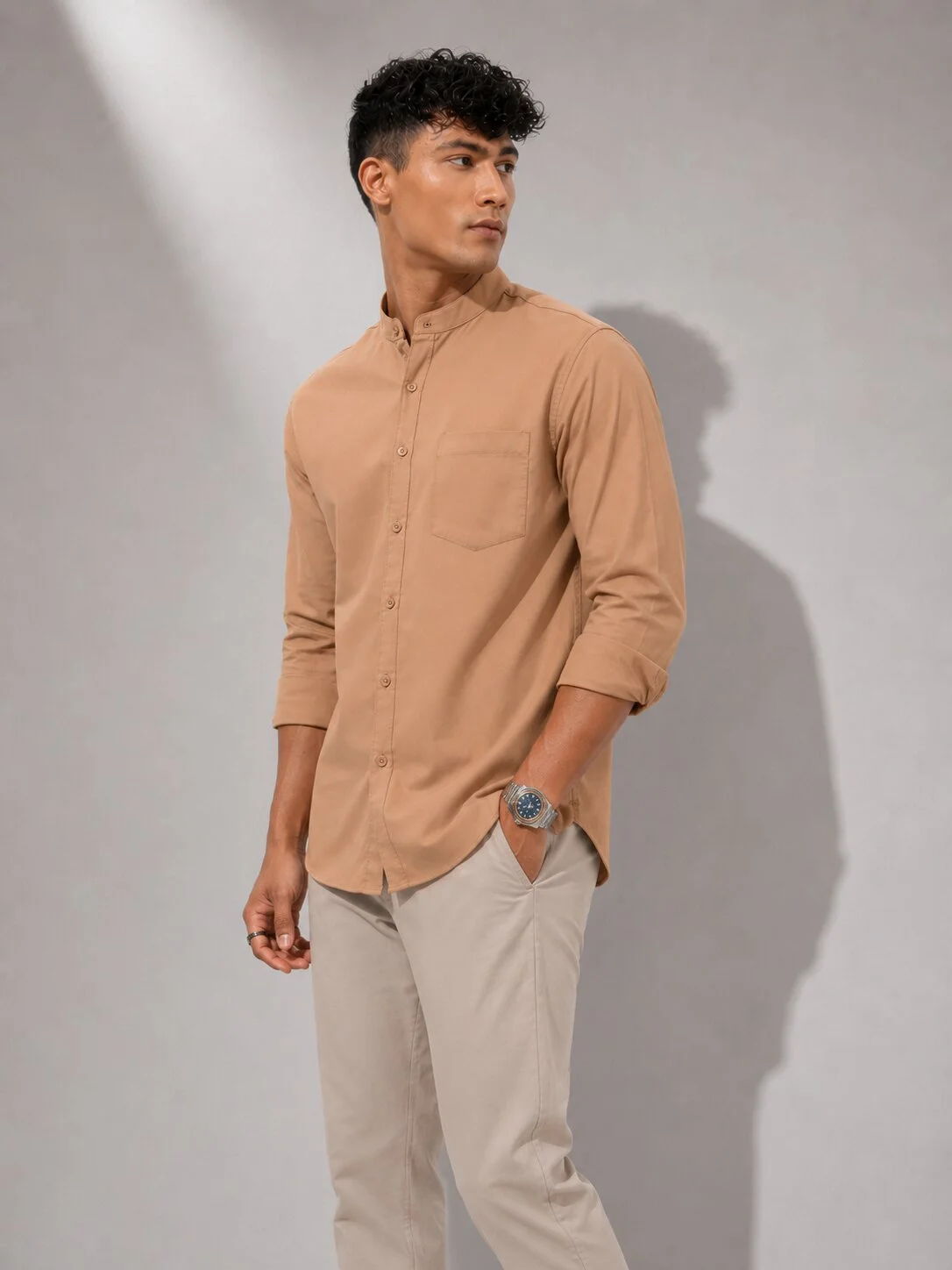 Peach shirt kurta worn by a model, front view showing mandarin collar, buttons, single chest pocket, and long sleeves