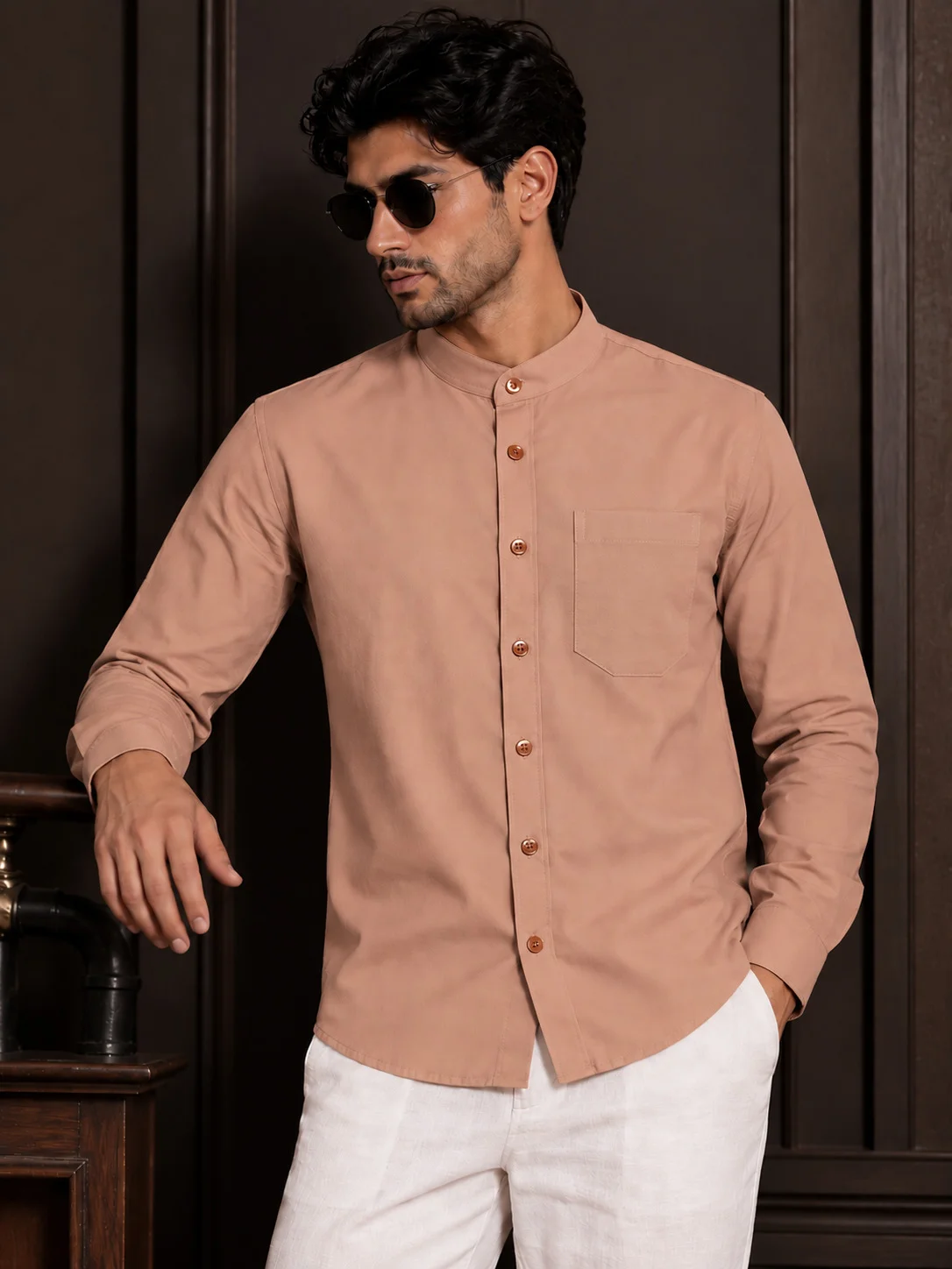 Front view of a model wearing a plain peach shirt with a mandarin collar, long sleeves, front buttons, and a chest pocket