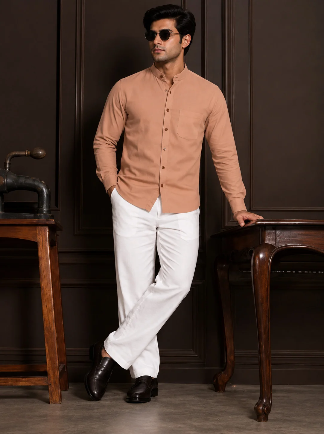 A model wearing a peach shirt kurta with mandarin collar, chest pocket, and full sleeves, paired with white trousers