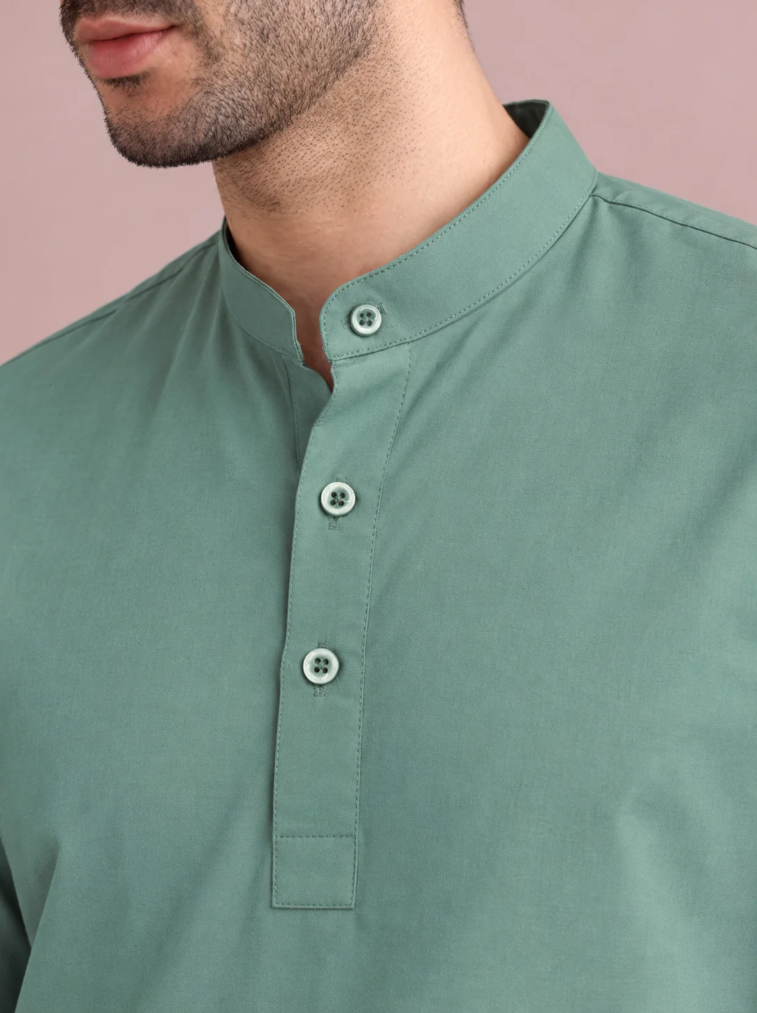 Mint green kurta, mandarin collar, four buttons, worn by a model, close-up