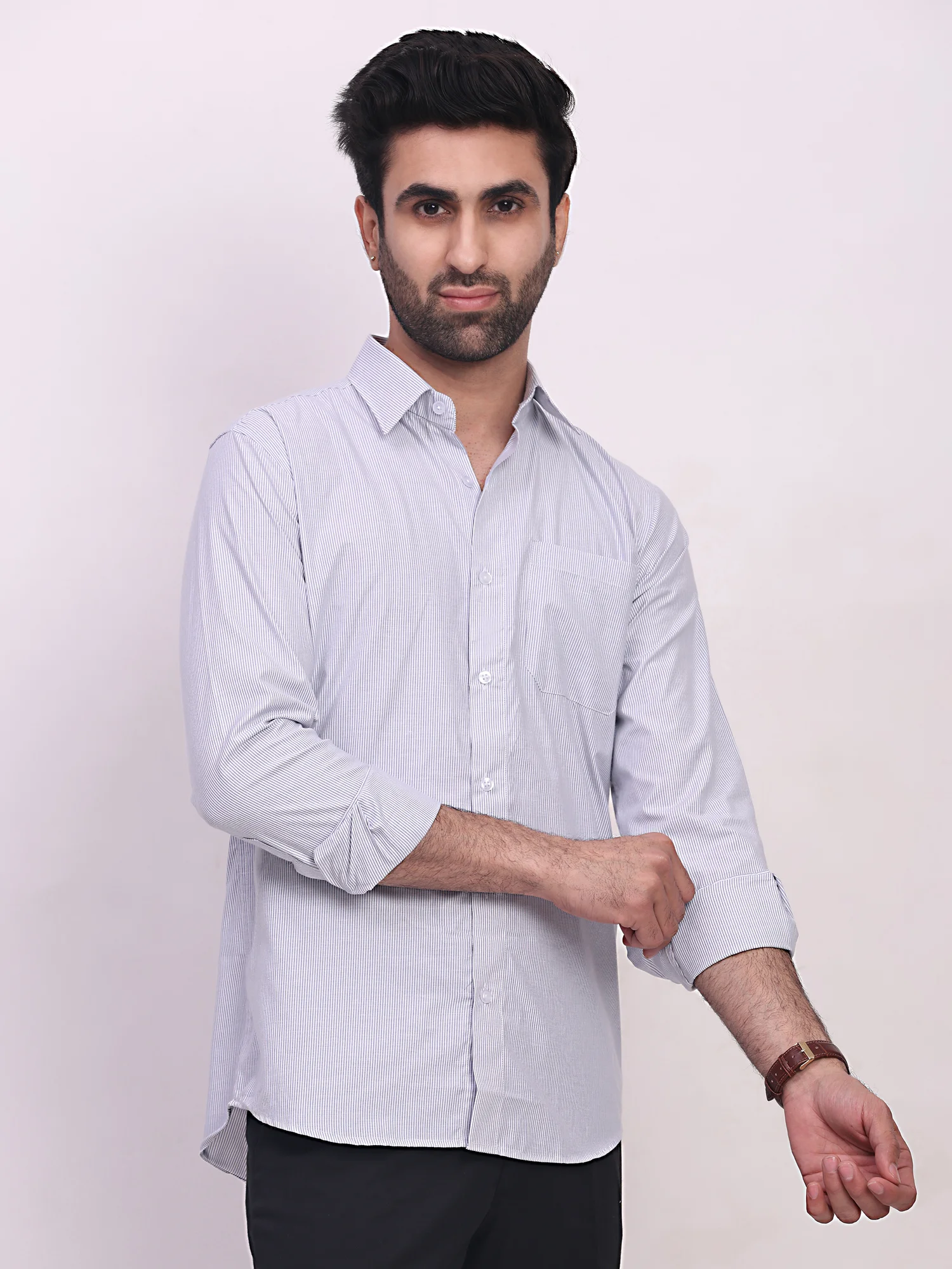 Sky blue striped shirt, front view, worn by a model, collar, buttons, pockets, rolled sleeves visible