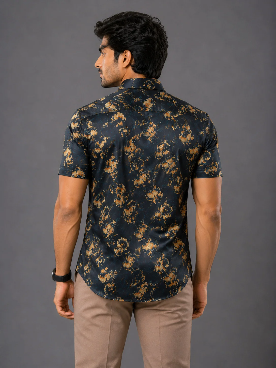 Short-sleeved shirt, navy blue with gold floral print, back view, worn by a model
