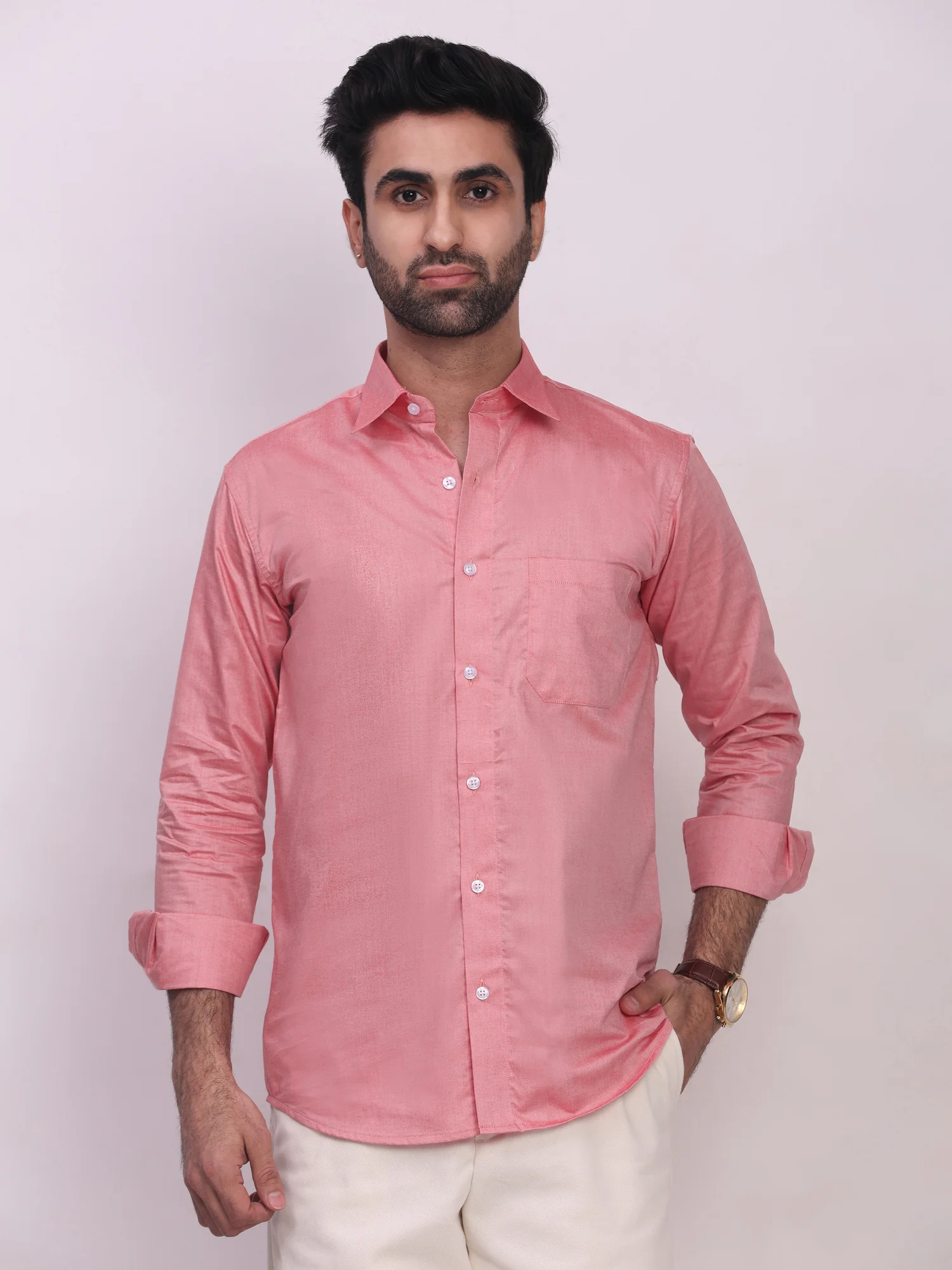 Pink button-down shirt, front view, on model, collar spread, cuffs rolled, one pocket visible
