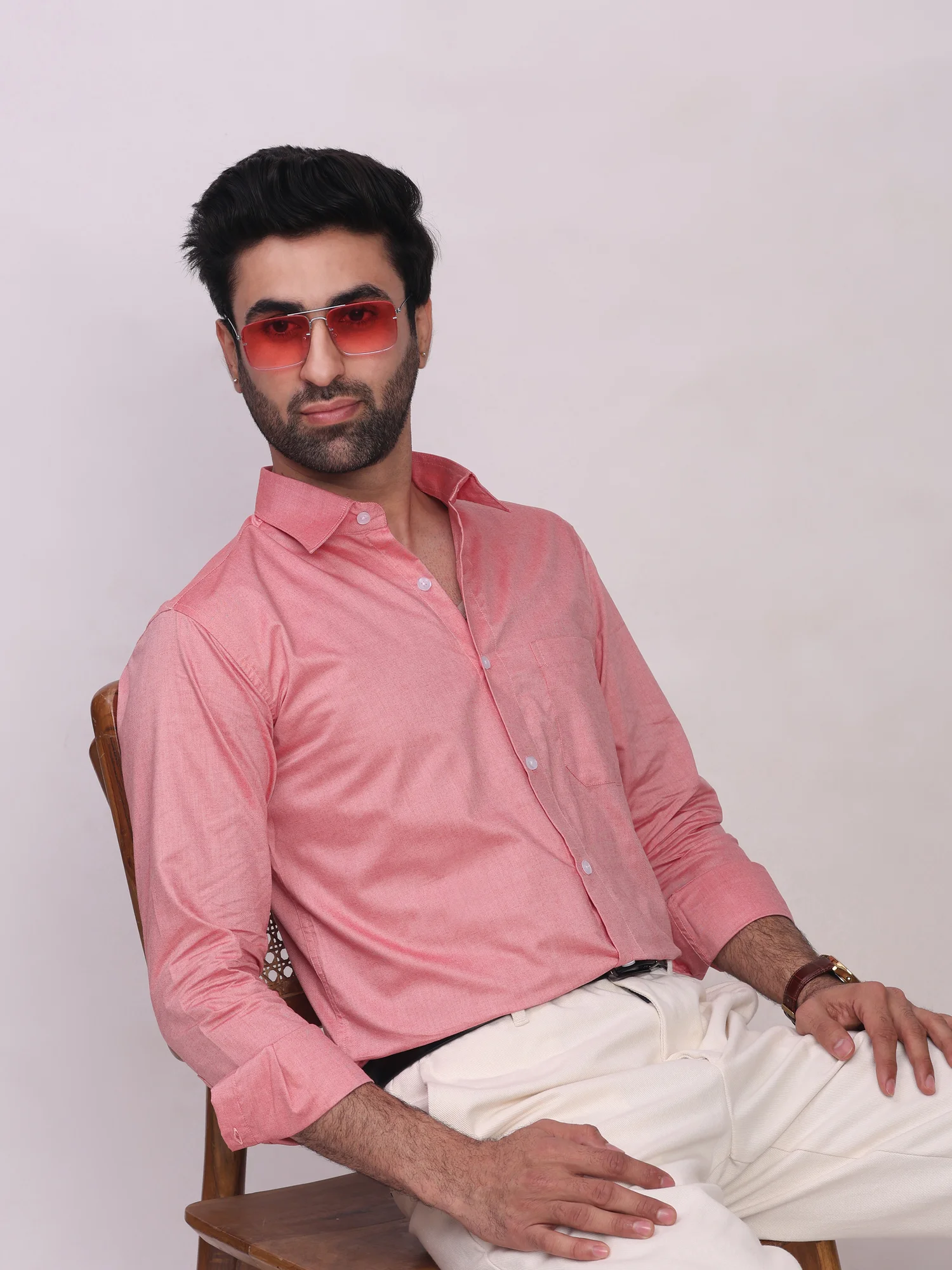 Pink button-down shirt, long sleeves, collar, one chest pocket, worn by a model