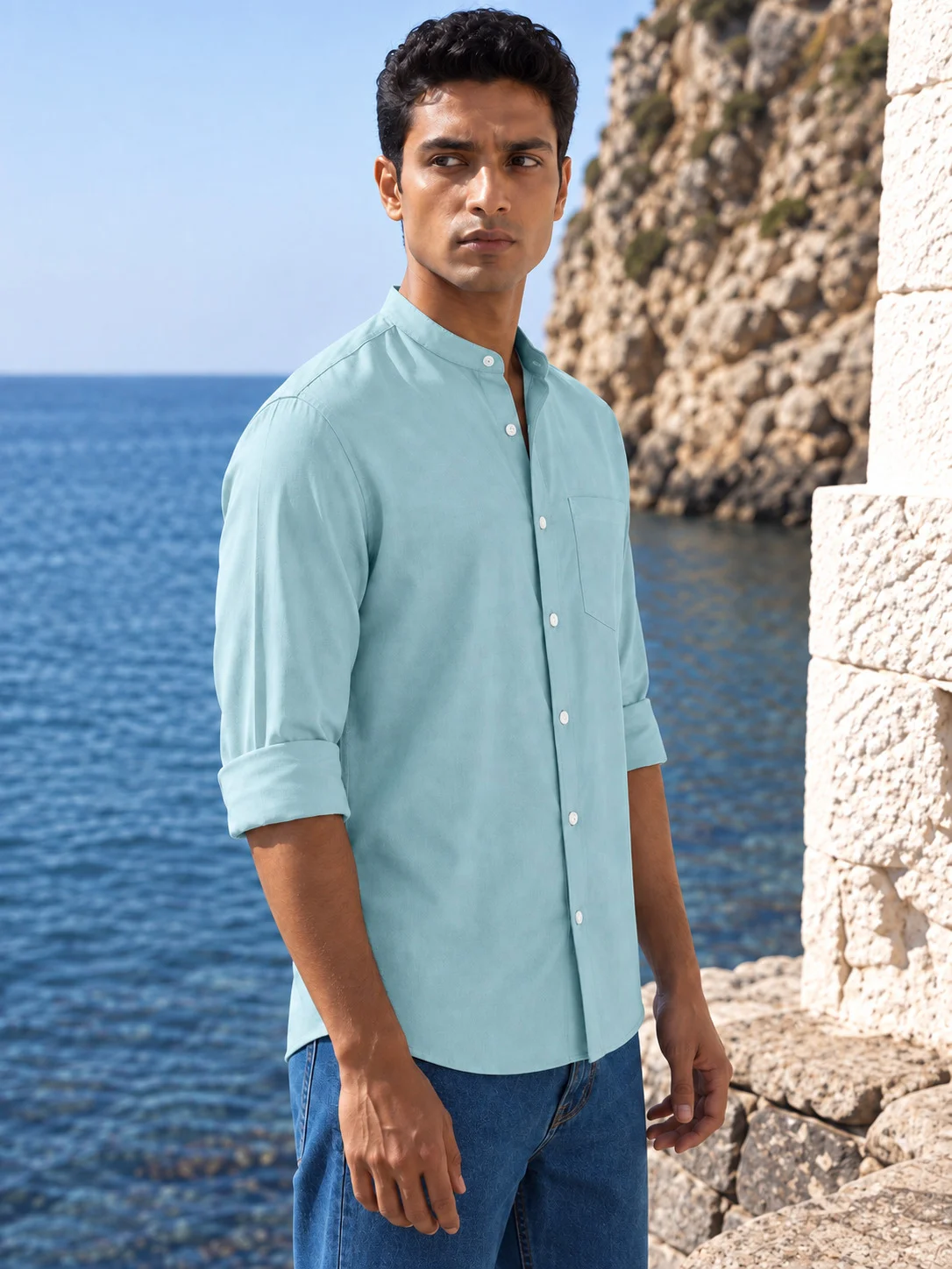 Model wearing sea green long-sleeve short kurta with mandarin collar and chest pocket by the sea