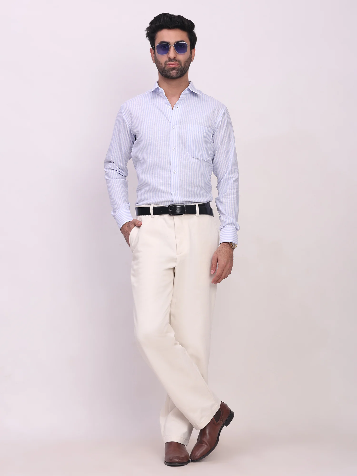 Front view of a model wearing a sky blue striped long-sleeve shirt with a collar and chest pocket