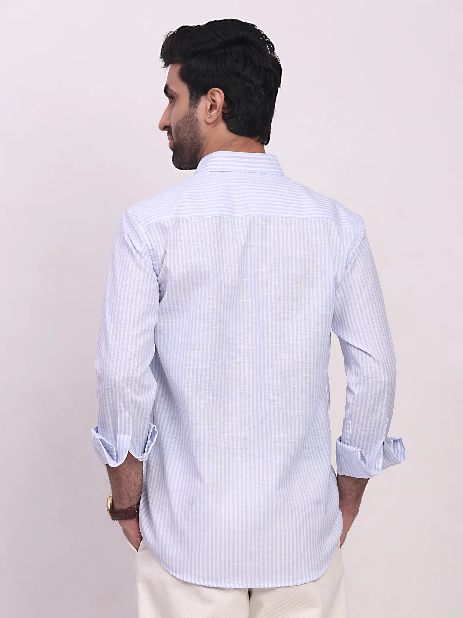 Sky blue striped shirt, back view, worn by a model, long sleeves, cuffed