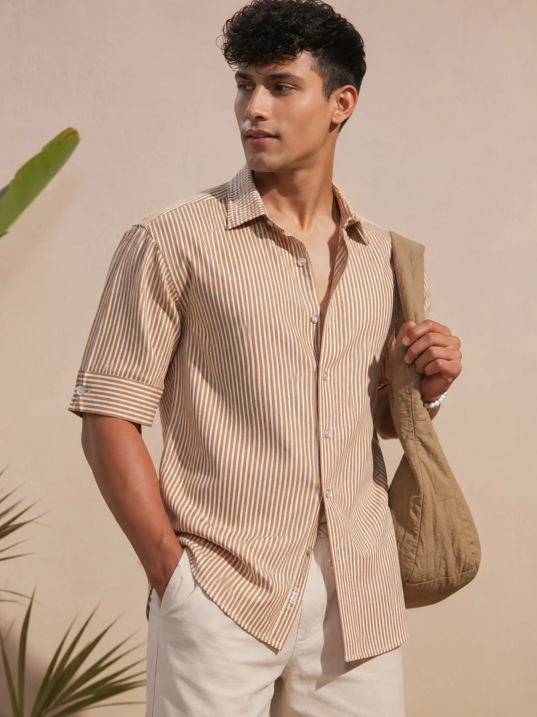 Striped short-sleeve shirt, beige and white, collar, buttons, worn by a model