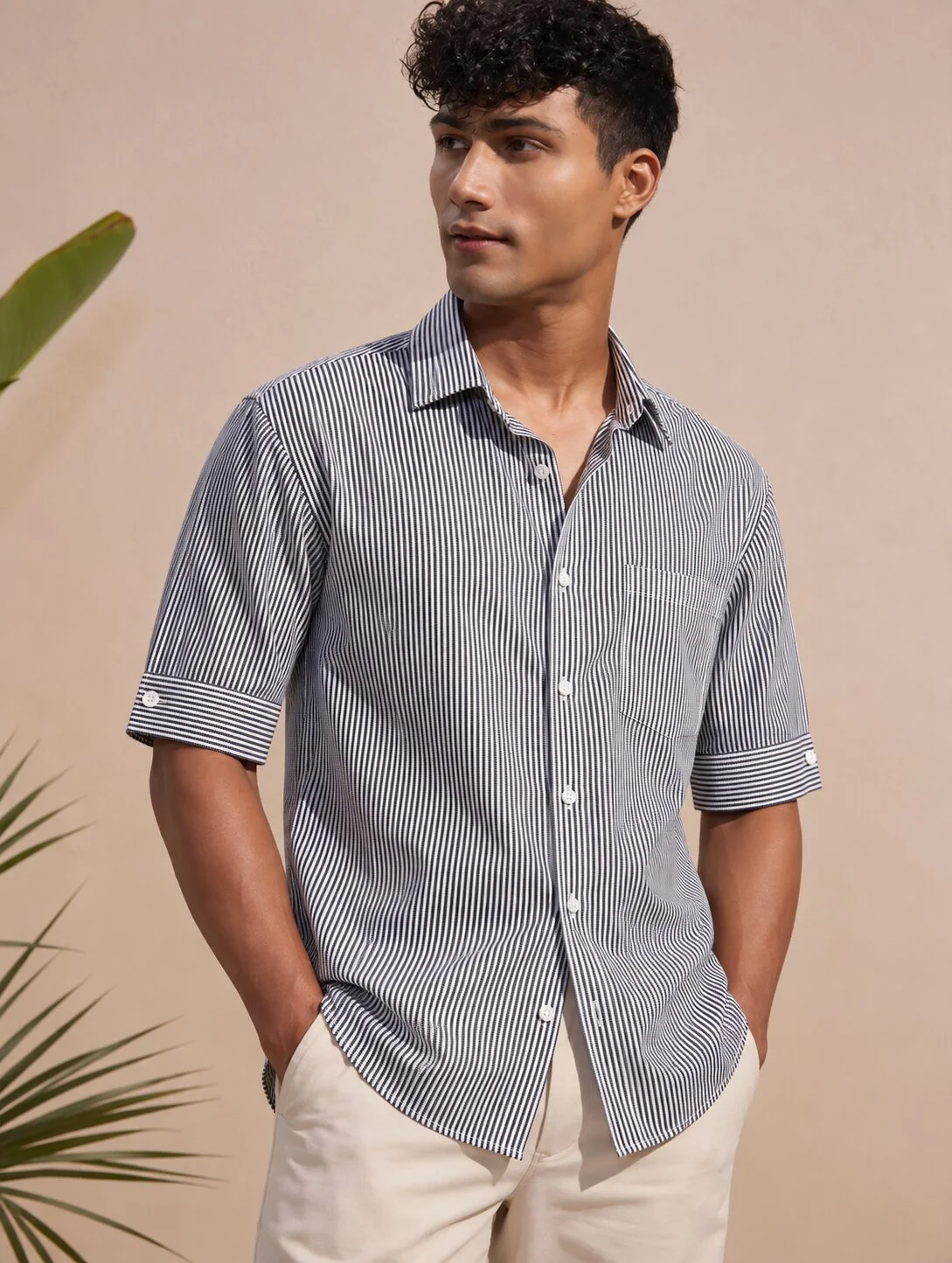 Short sleeved shirt, black and white stripes, collar, buttons, worn by a model