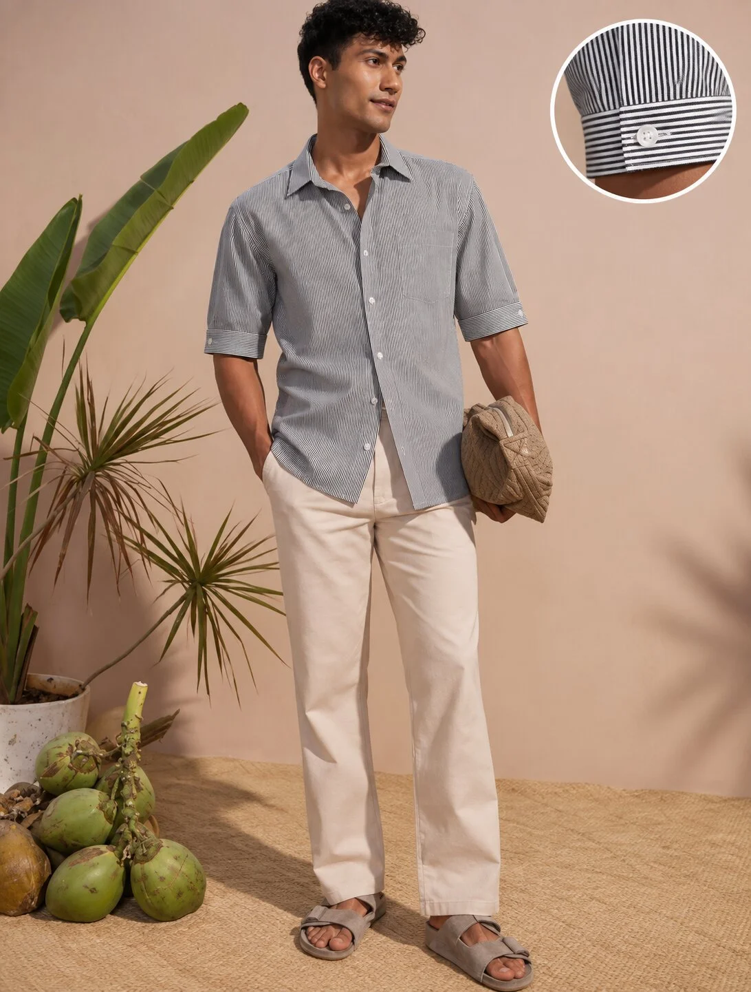 Grey and white striped short-sleeved shirt, worn by a model, buttoned collar, white buttons