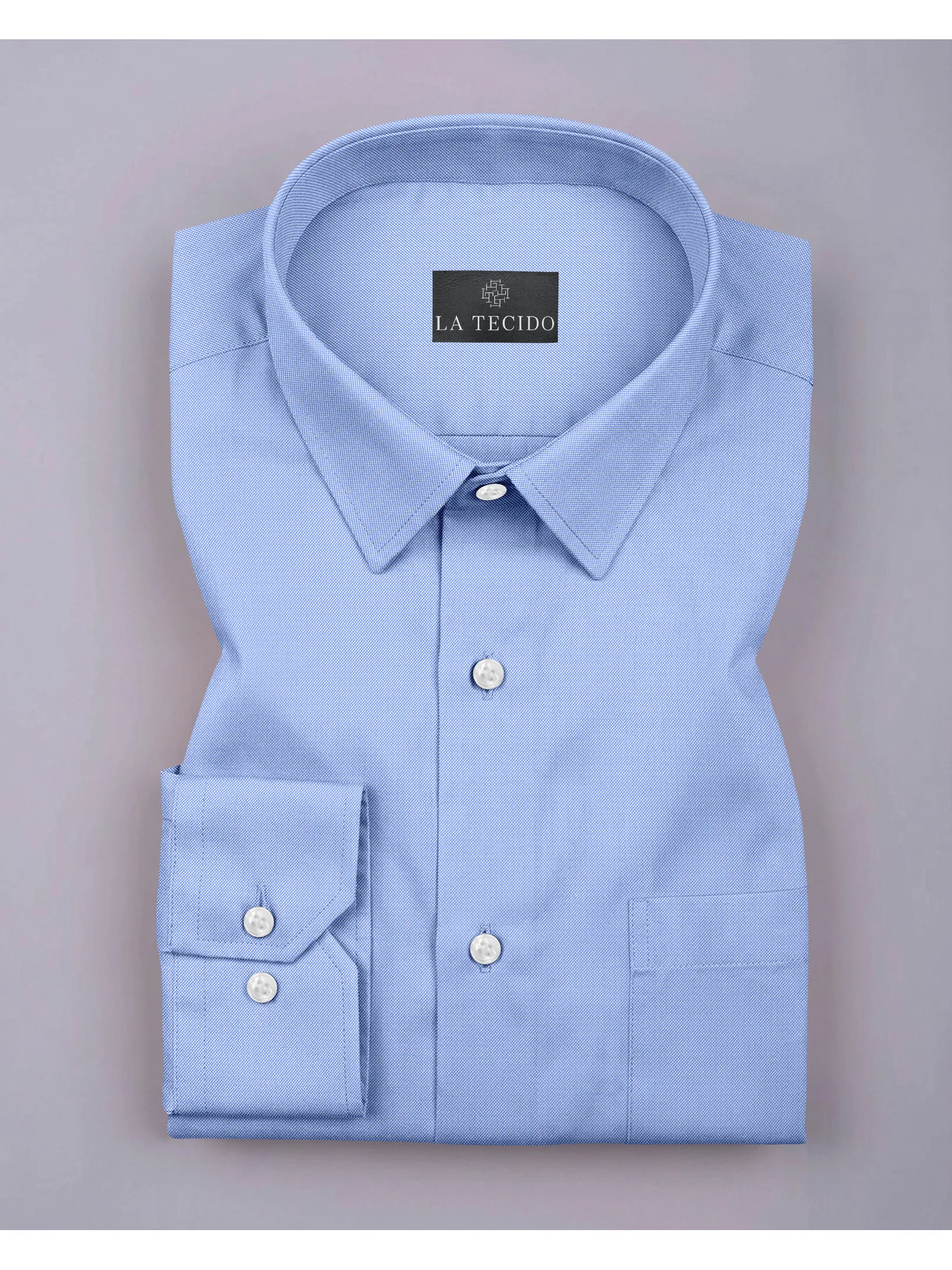 Flat lay of a folded sky blue long-sleeve shirt with collar, front buttons, and a chest pocket