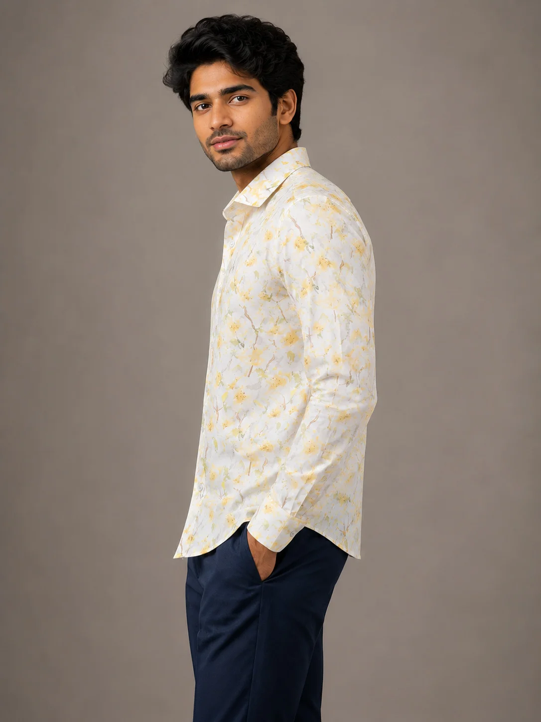 White and yellow floral patterned shirt, collar and long sleeves, worn by a model