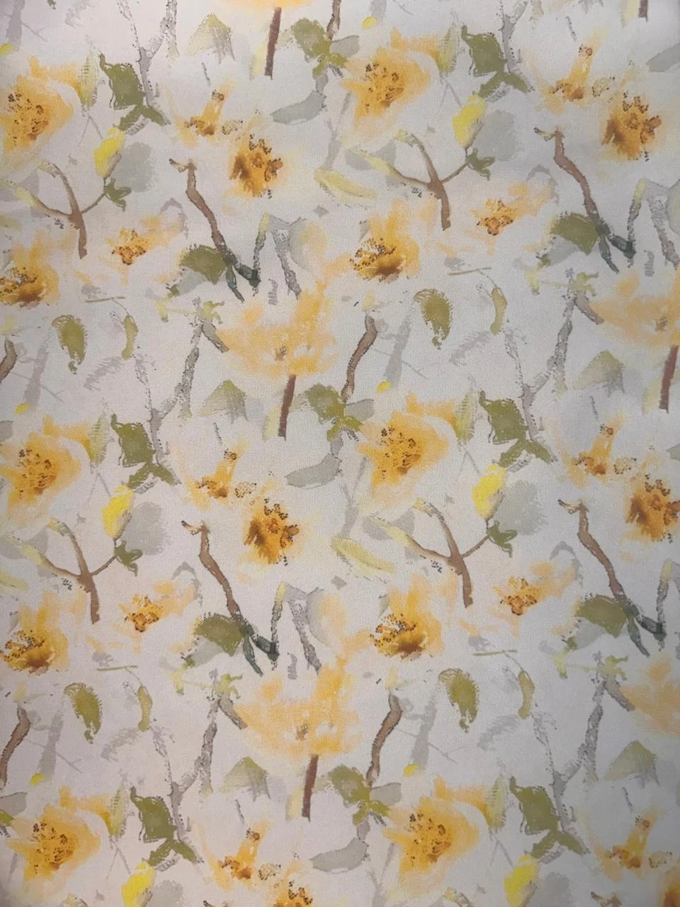Floral pattern on white background with yellow flowers and green leaves. Flat lay, close-up