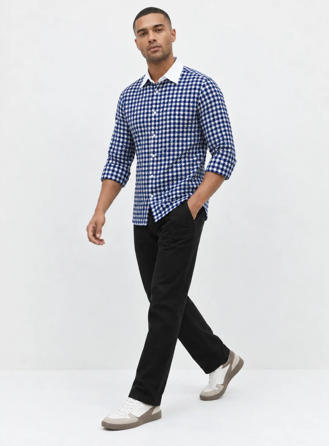 Blue and white checkered shirt, worn by a model, front view, white collar, rolled sleeves, buttons
