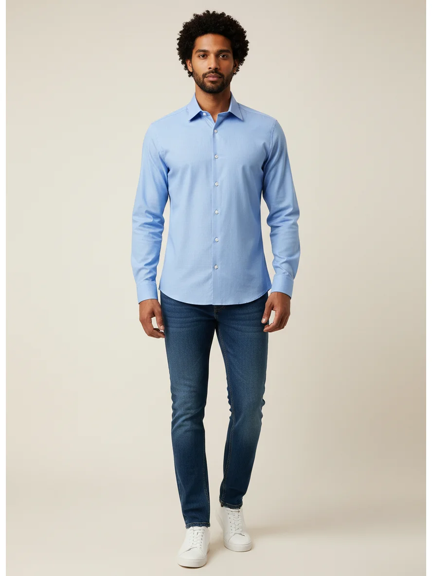 Model wearing light blue long-sleeve shirt with collar and front buttons, paired with blue jeans