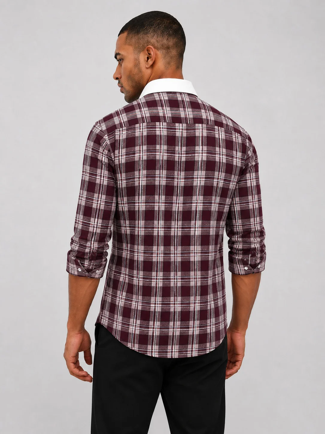 Back view of a maroon checkered shirt with white collar, worn by a model with rolled-up sleeves