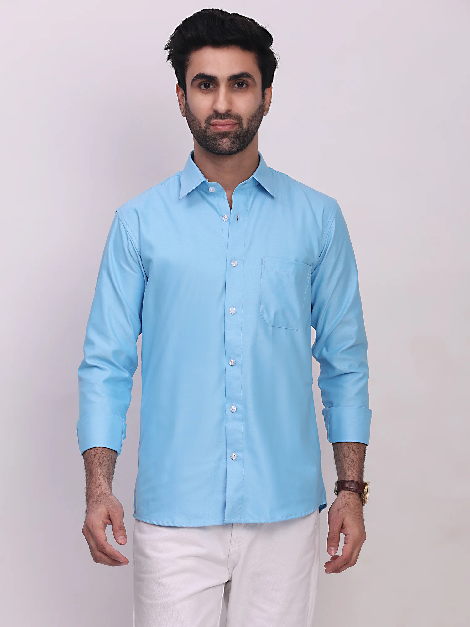 Front view of a model wearing a light blue long-sleeve shirt with a collar, button placket, and chest pocket