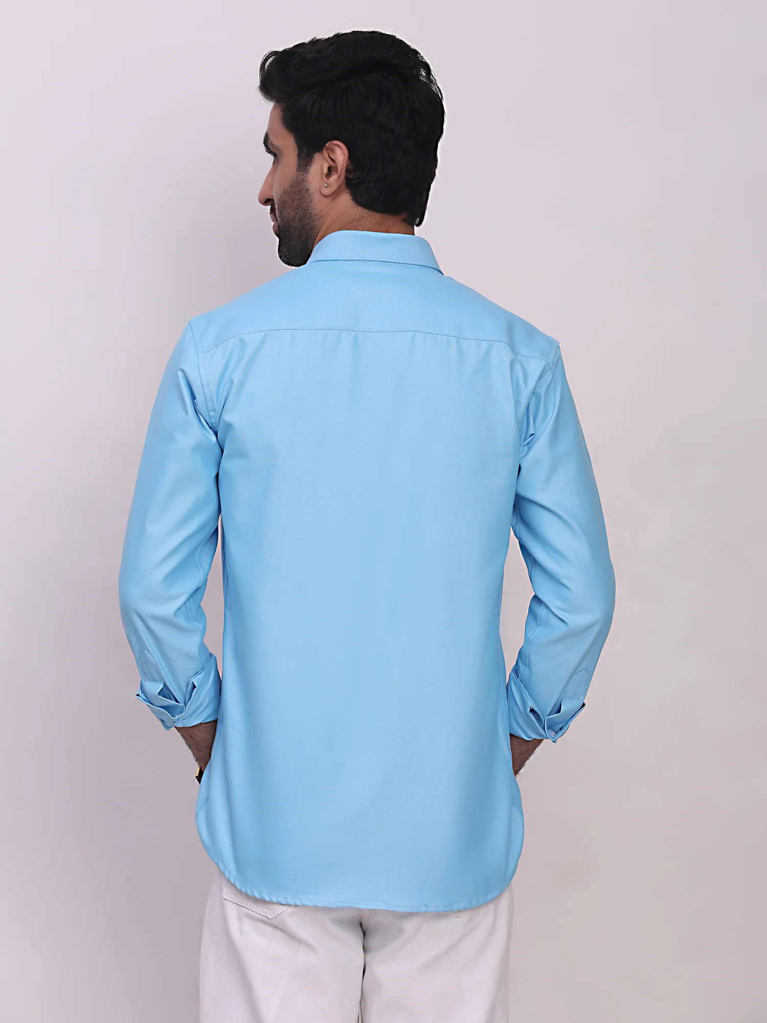 Back view of a model wearing a light blue long-sleeve shirt with collar and cuffs