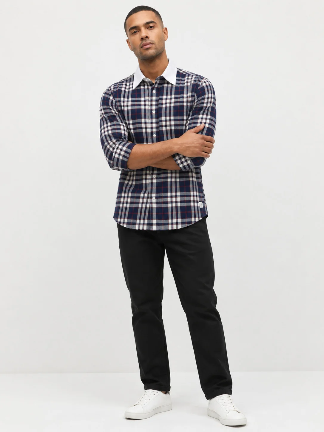 Navy blue, white, and red plaid shirt, worn by a model, front view, white collar, rolled sleeves, buttons