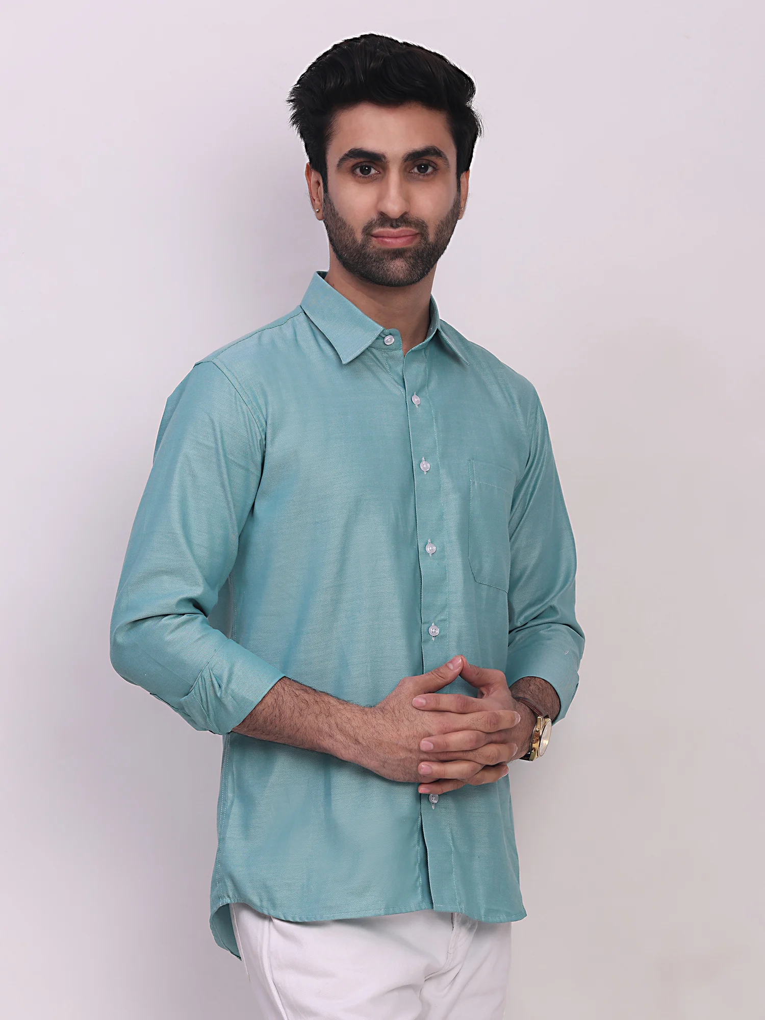 A model wearing a sea green long-sleeve shirt with a button-down collar and chest pocket, front view