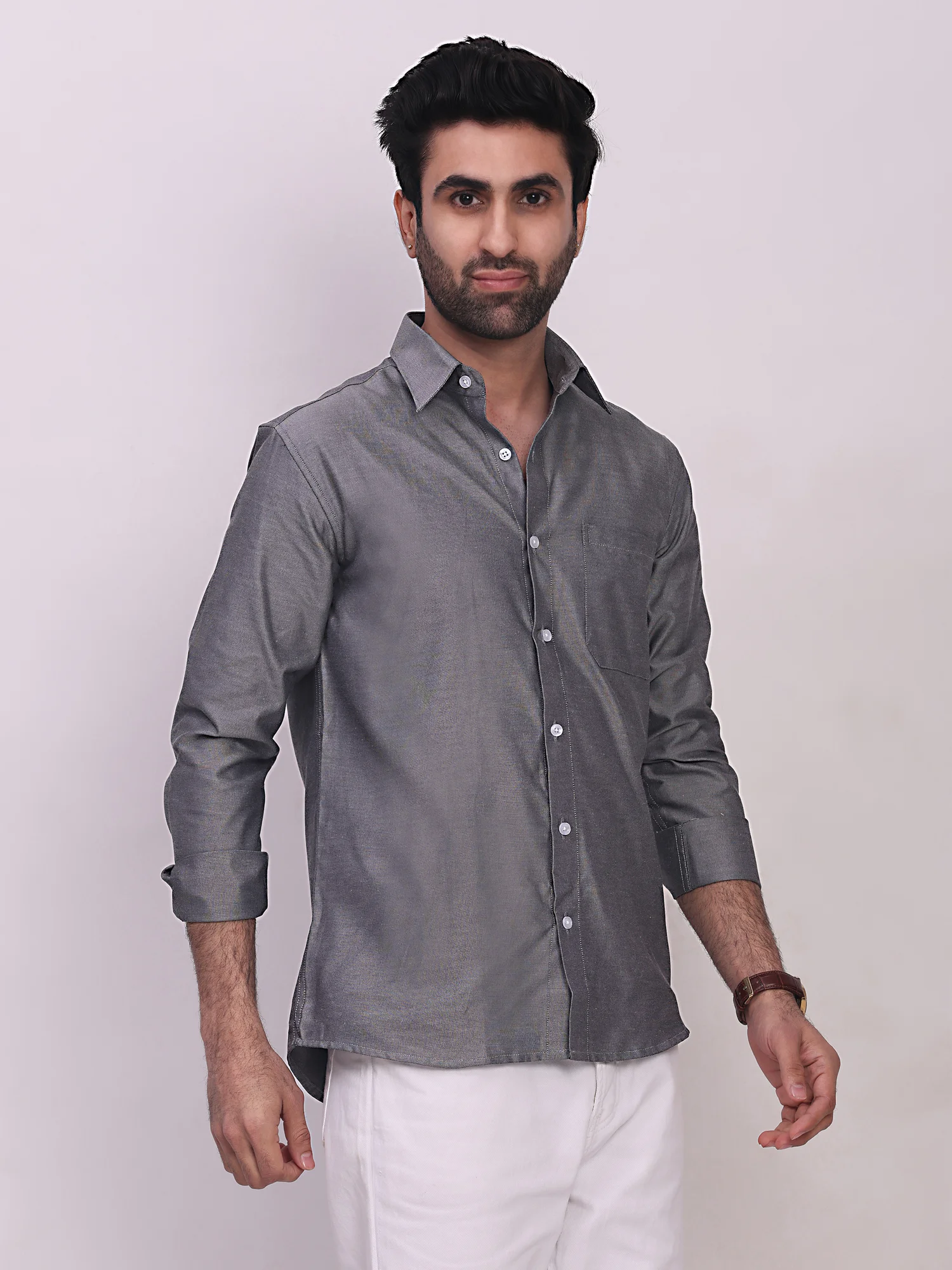 Front view of a model wearing a grey solid long-sleeve shirt with a collar, button placket, and a chest pocket