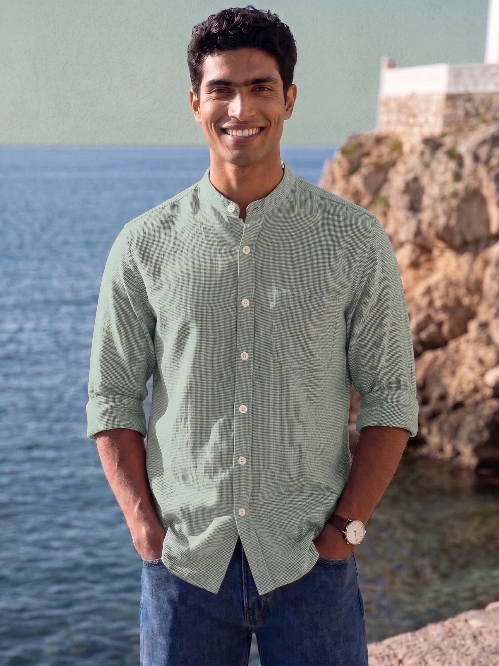 Green mandarin collar shirt, rolled sleeves, buttoned front, worn by a model