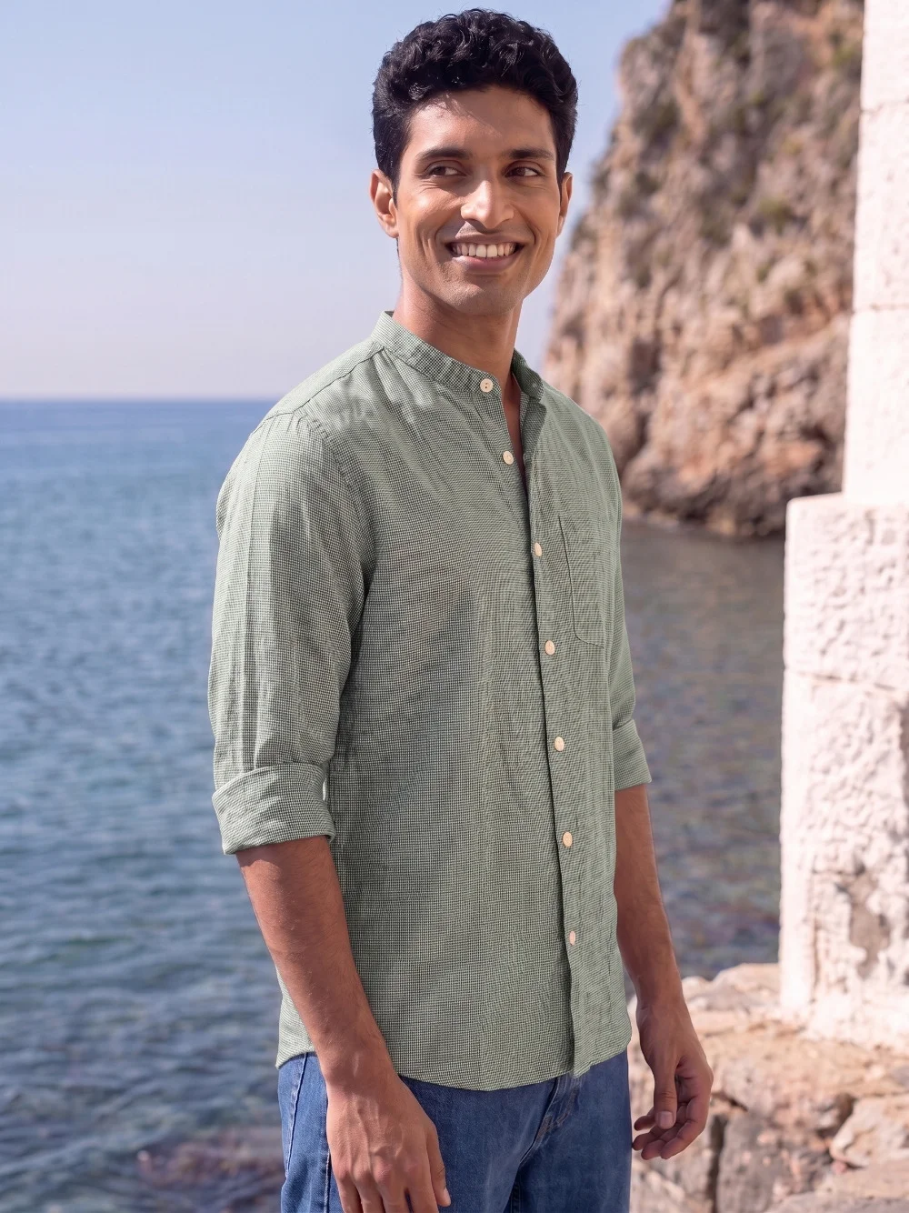 Green kurta with mandarin collar, rolled sleeves, and buttons down front