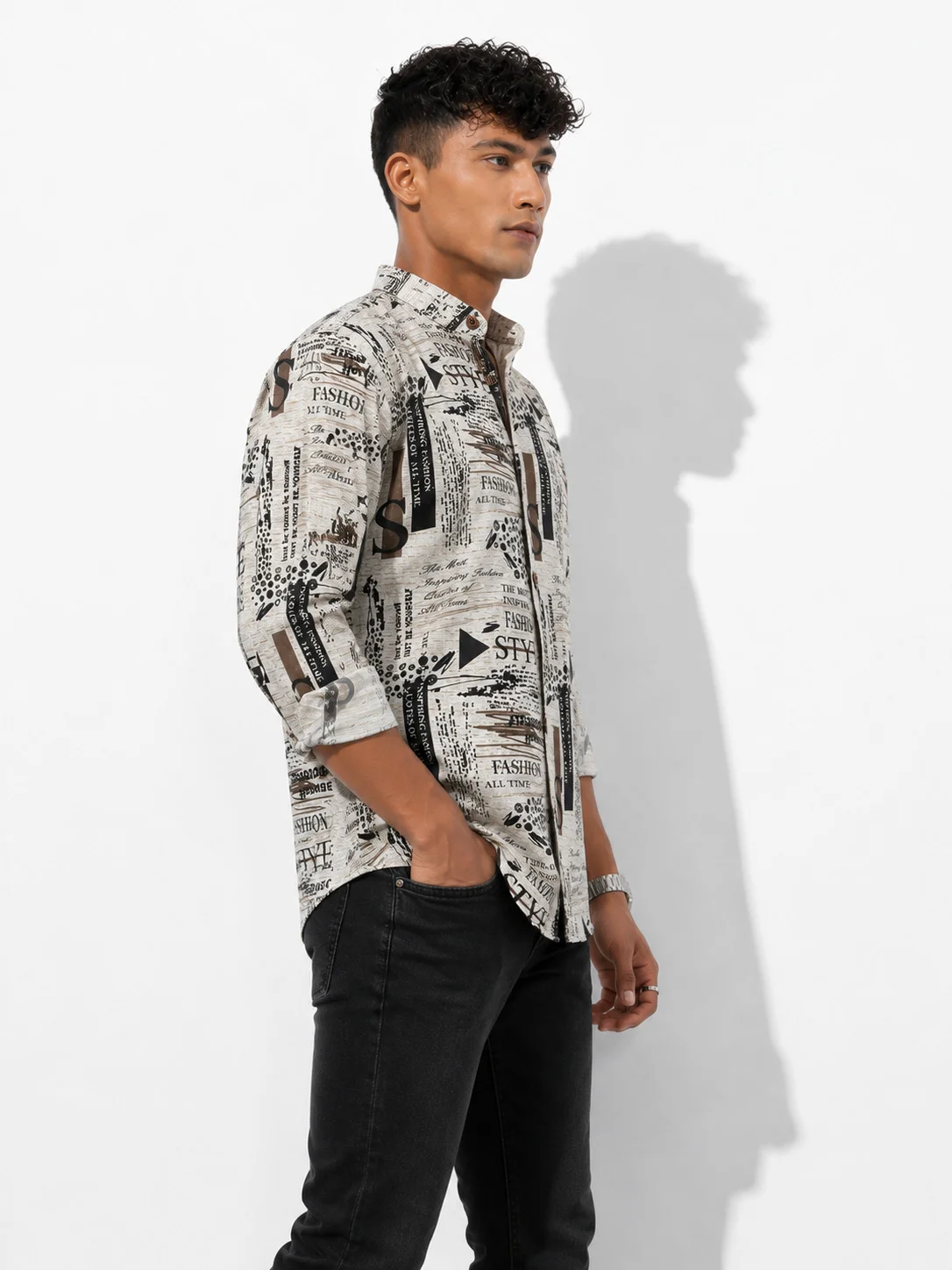 Shirt, white with black print, worn by model, side view, collar, buttons, rolled sleeves