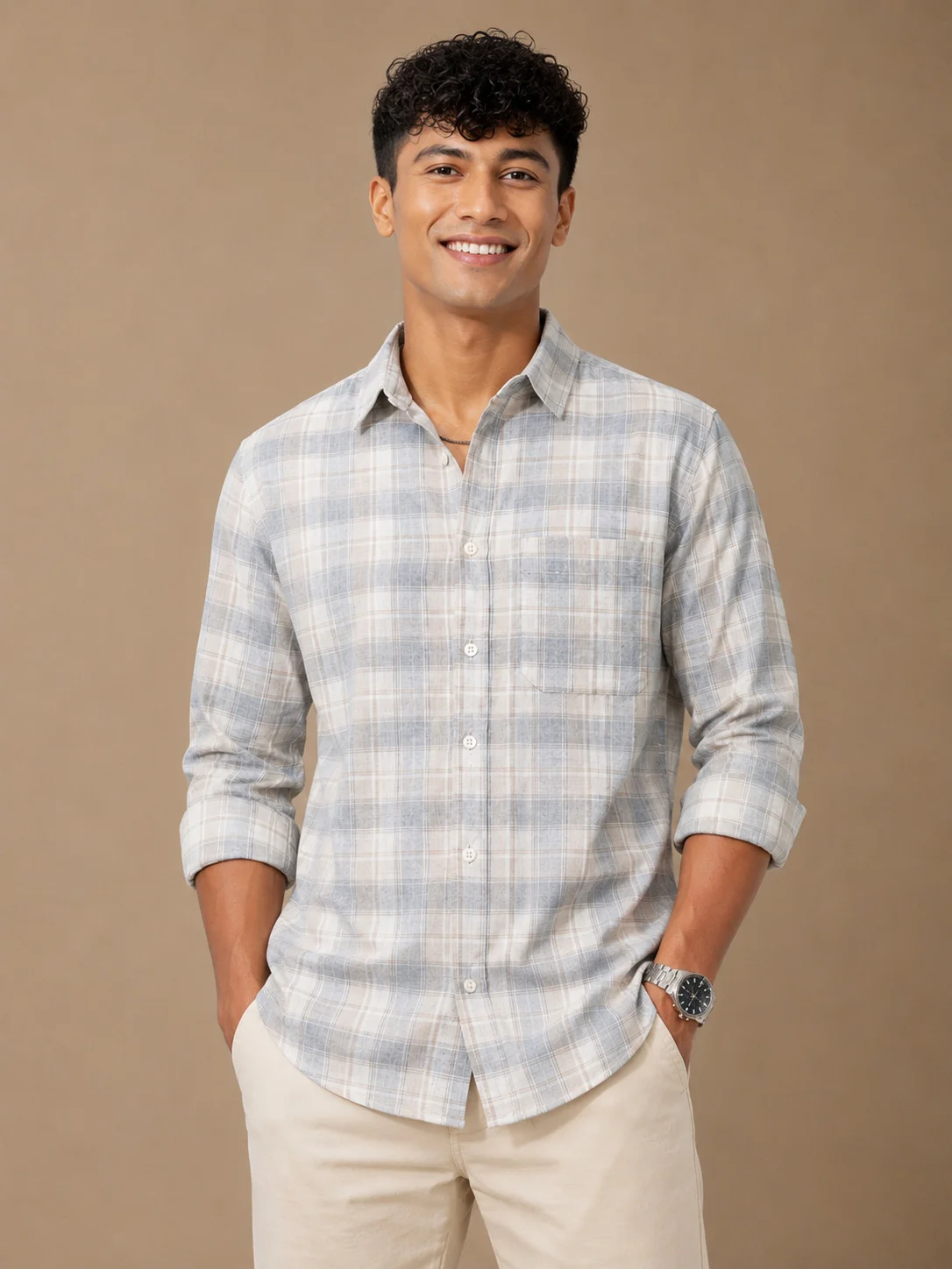 Shirt, light grey and white plaid, collar, buttons, long sleeves rolled up, chest pocket. Worn by a model