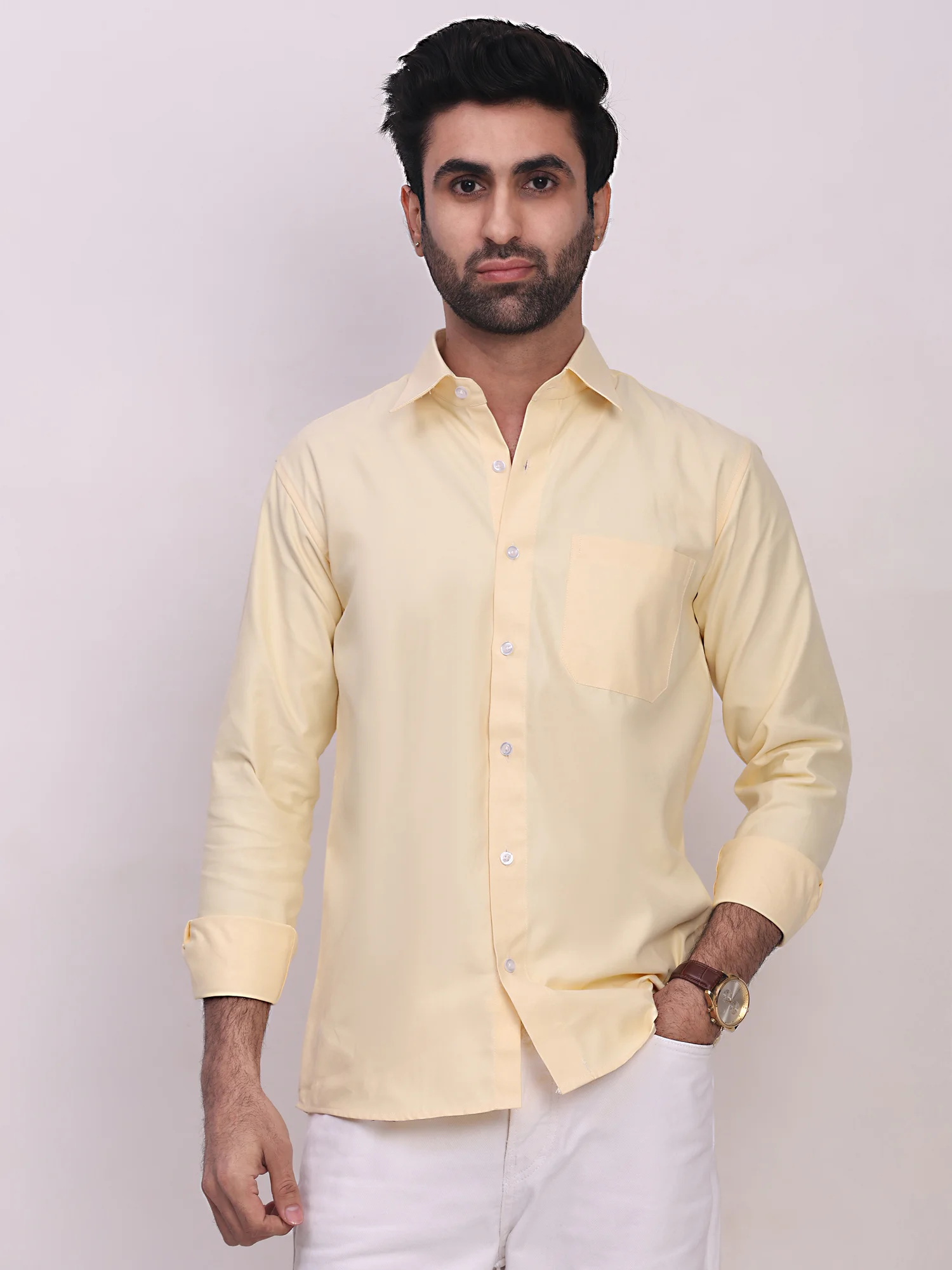 A model wears a light yellow long-sleeve shirt with a front pocket and buttoned placket
