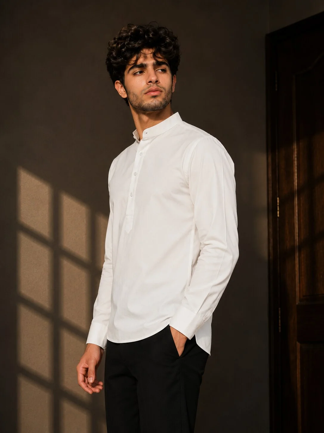White kurta, long sleeves, mandarin collar, buttons down front, worn by a model