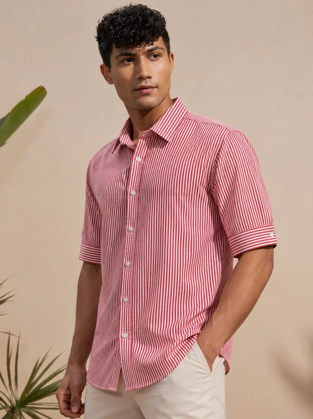 Pink and white striped short-sleeved shirt, collar, buttons, worn by a model
