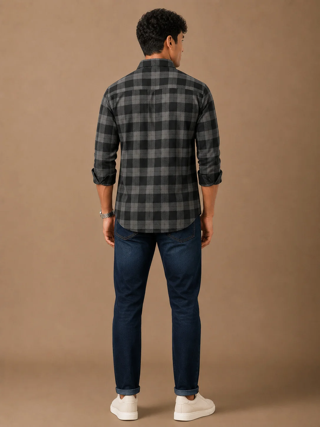 Black and grey checkered shirt, back view, worn by a model, collar visible, sleeves rolled up