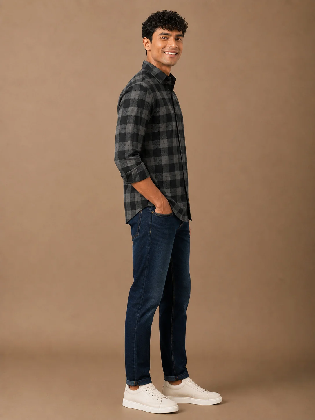 Black and grey checkered shirt, worn by a model, side view, long sleeves, collar visible