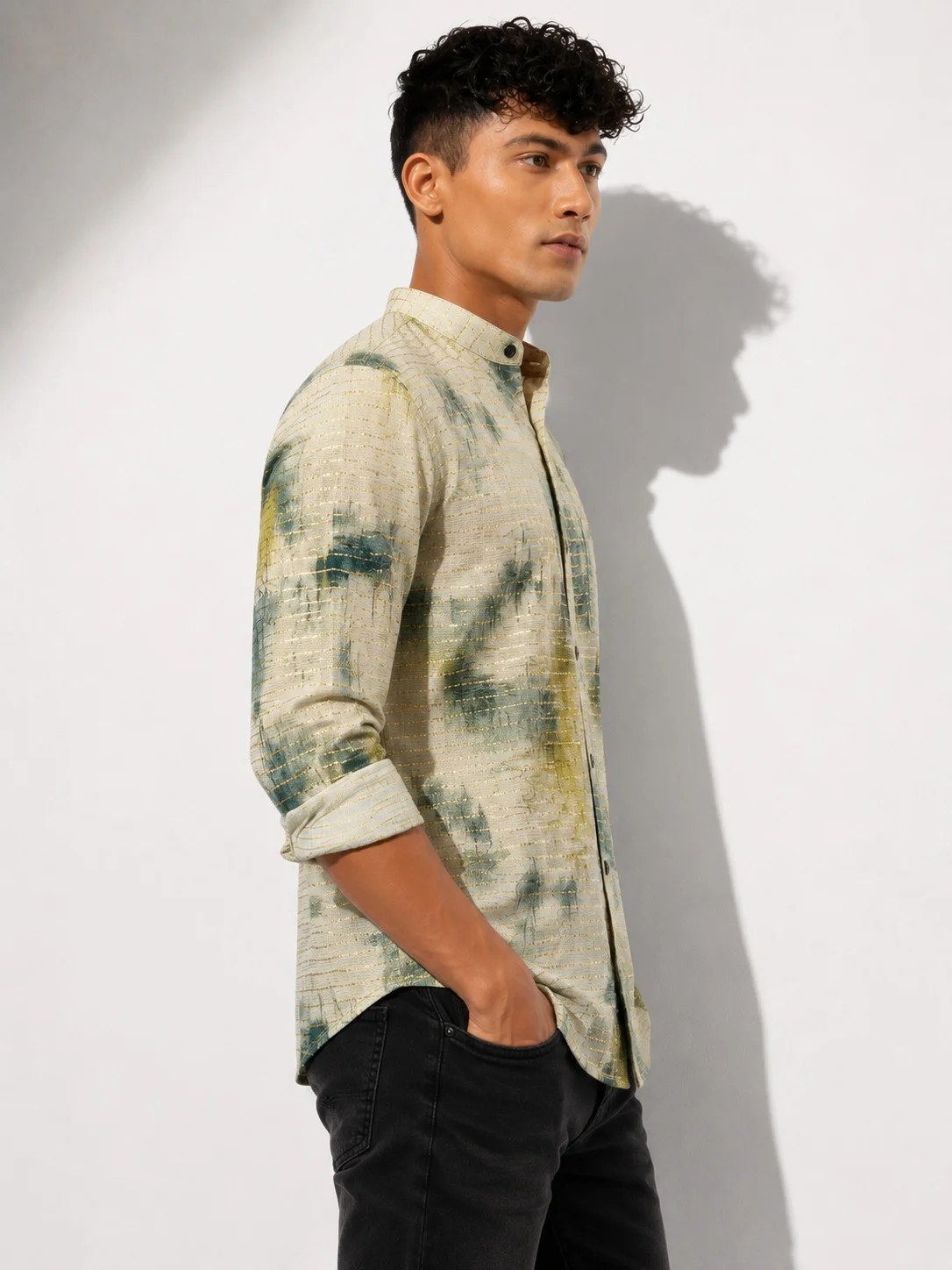 Shirt, beige with green and yellow pattern, collar, buttons, long sleeves rolled up, worn by a model