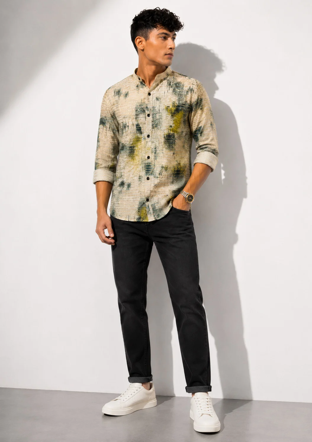 Long sleeve shirt, beige with green and yellow splashes, worn by a model, front view, cuffed sleeves, buttons down front