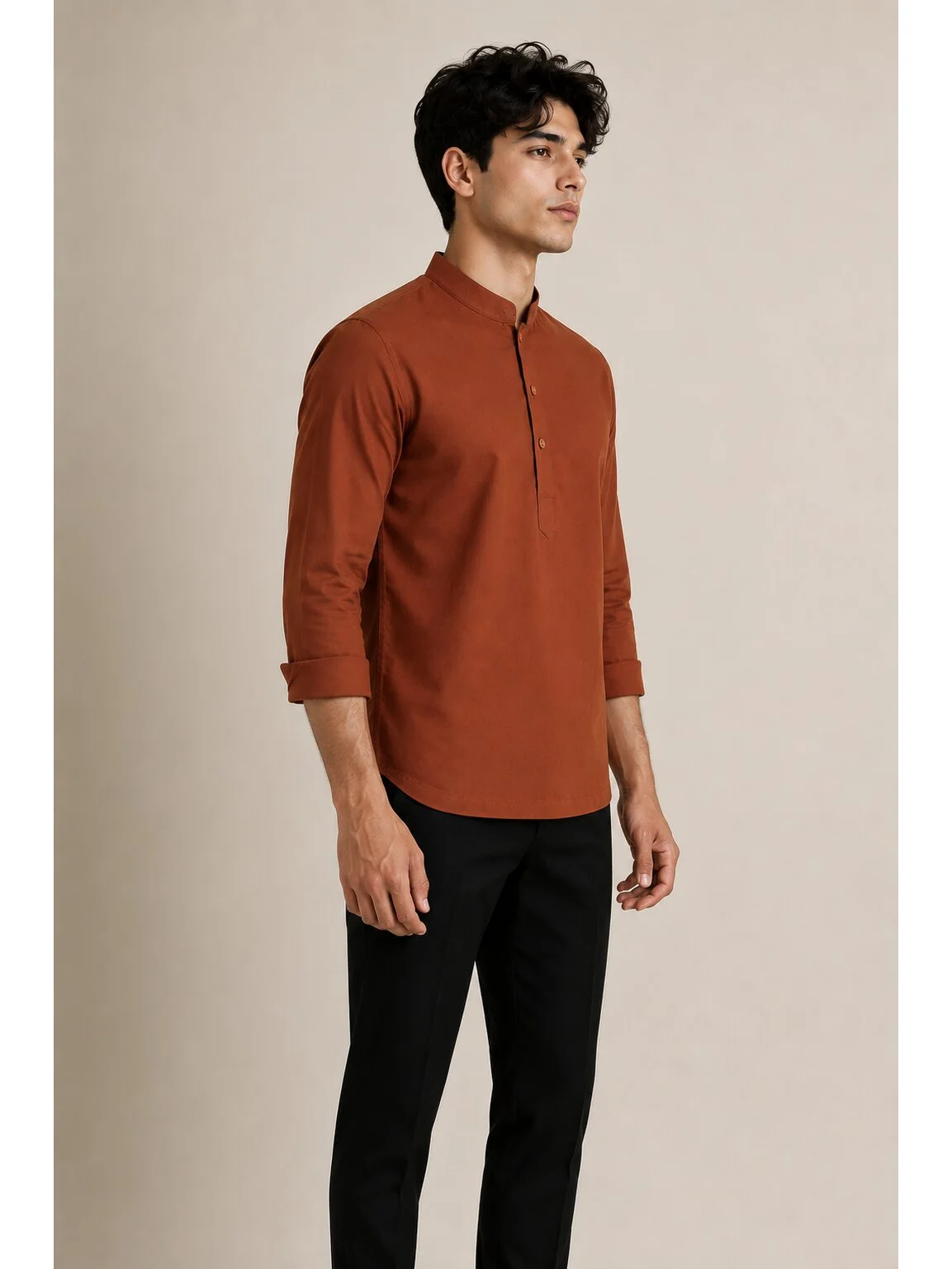 Model wears rust brown short kurta with mandarin collar and rolled-up sleeves, side view