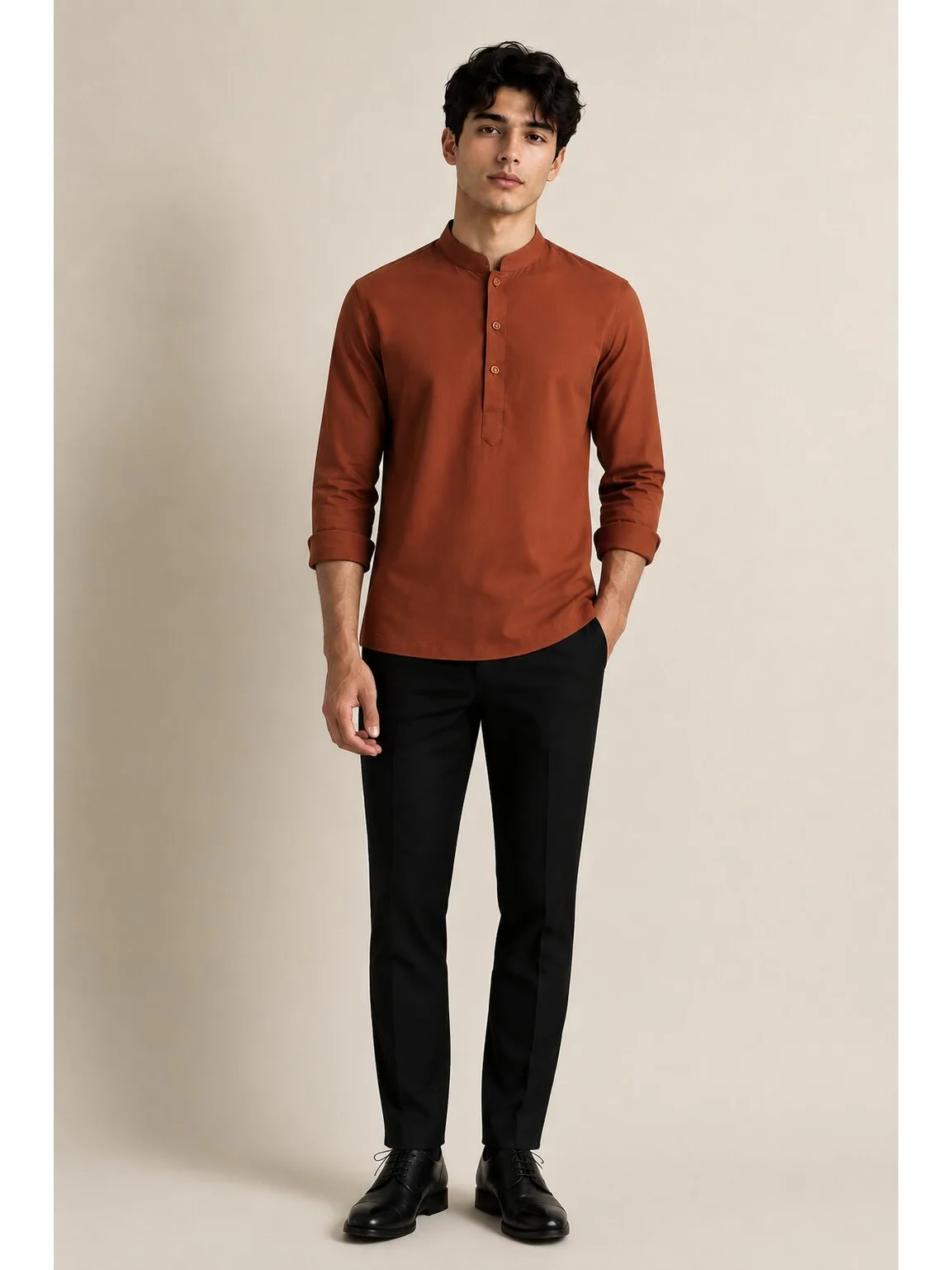 Front view of a model wearing a rust brown short kurta with mandarin collar and long sleeves