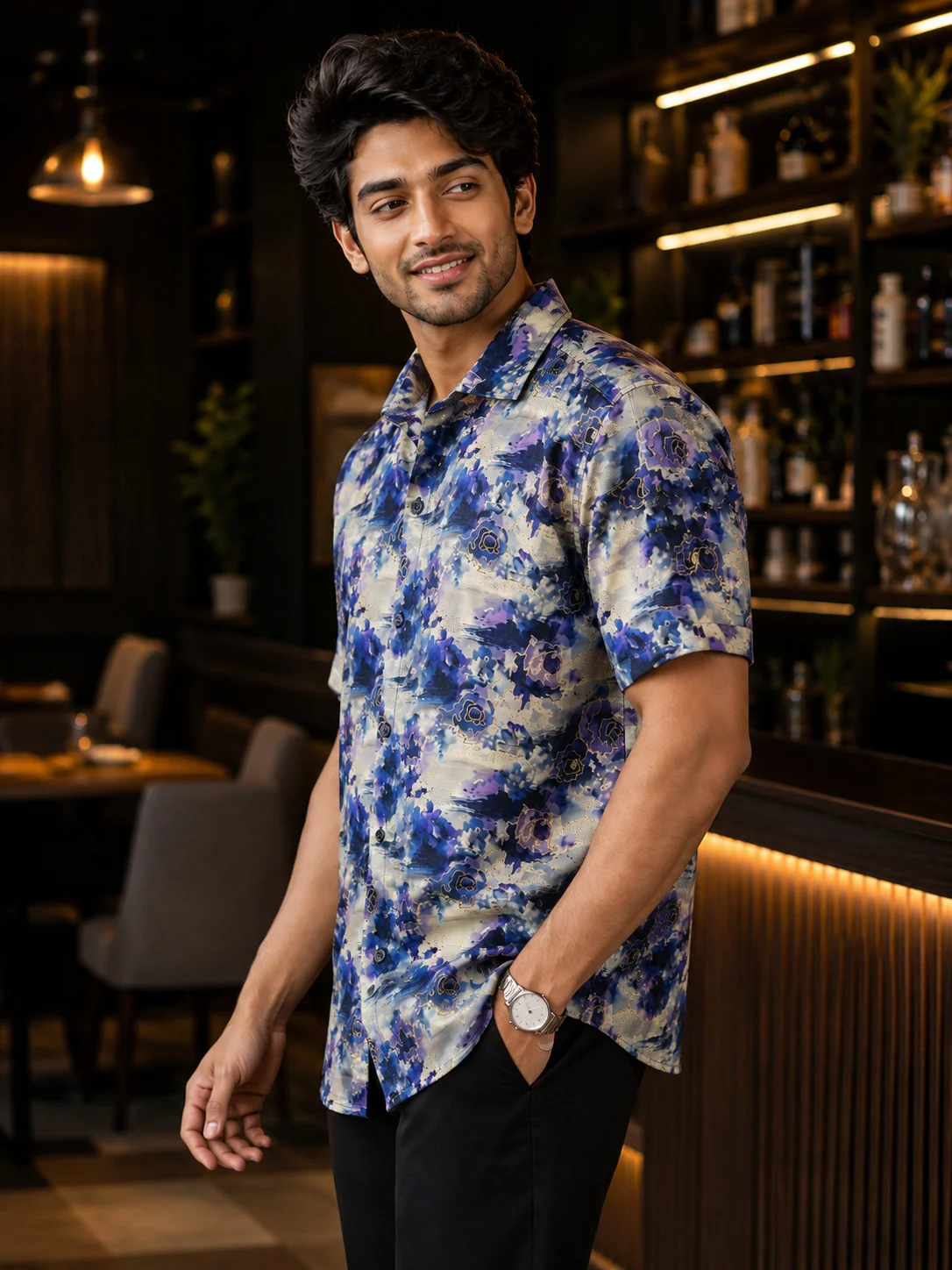Blue floral print short-sleeve shirt, worn by a model, buttons, collar visible