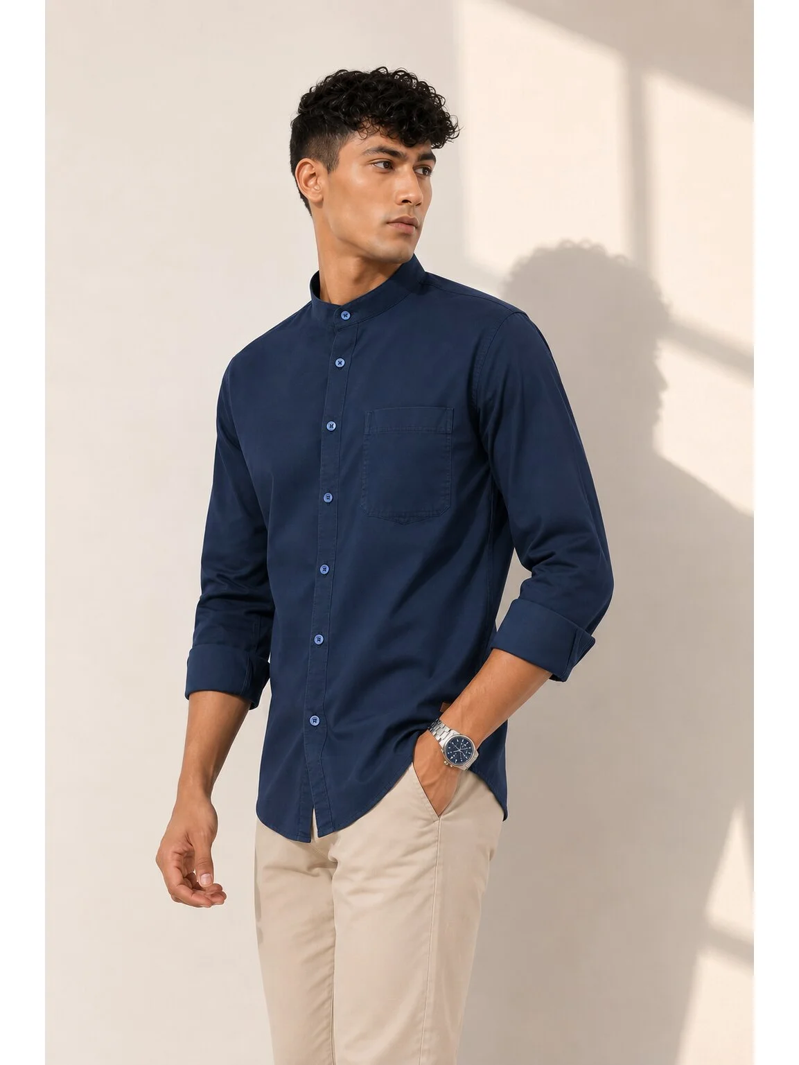 Model wearing a solid navy blue shirt kurta with a mandarin collar, front buttons, and a chest pocket