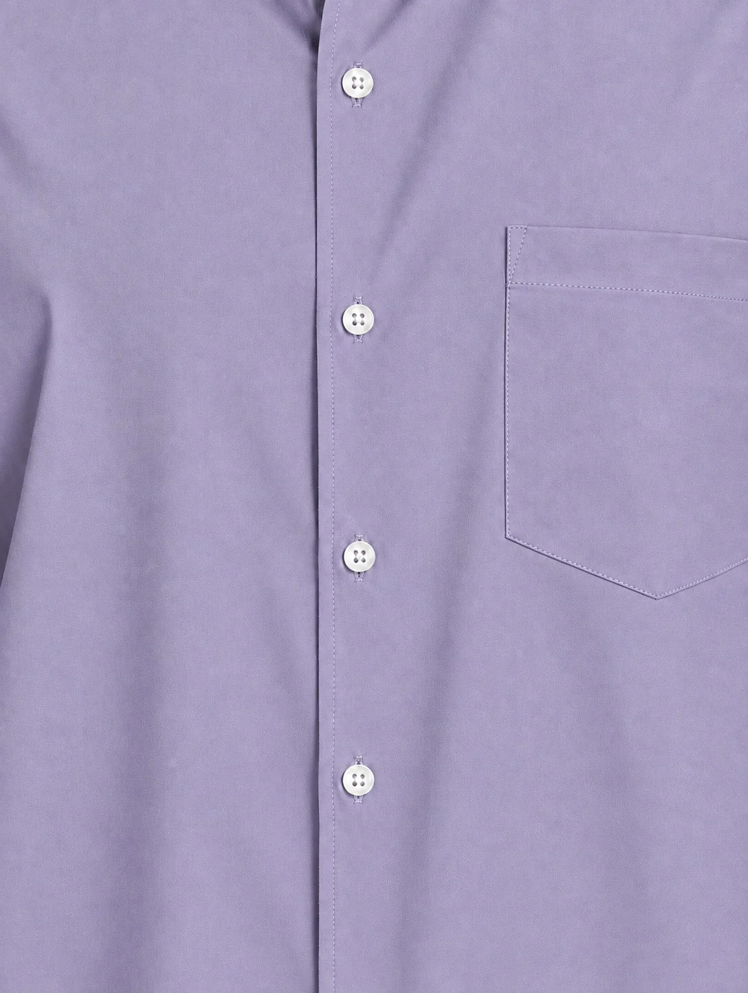 Close-up of a purple shirt with white buttons and a chest pocket