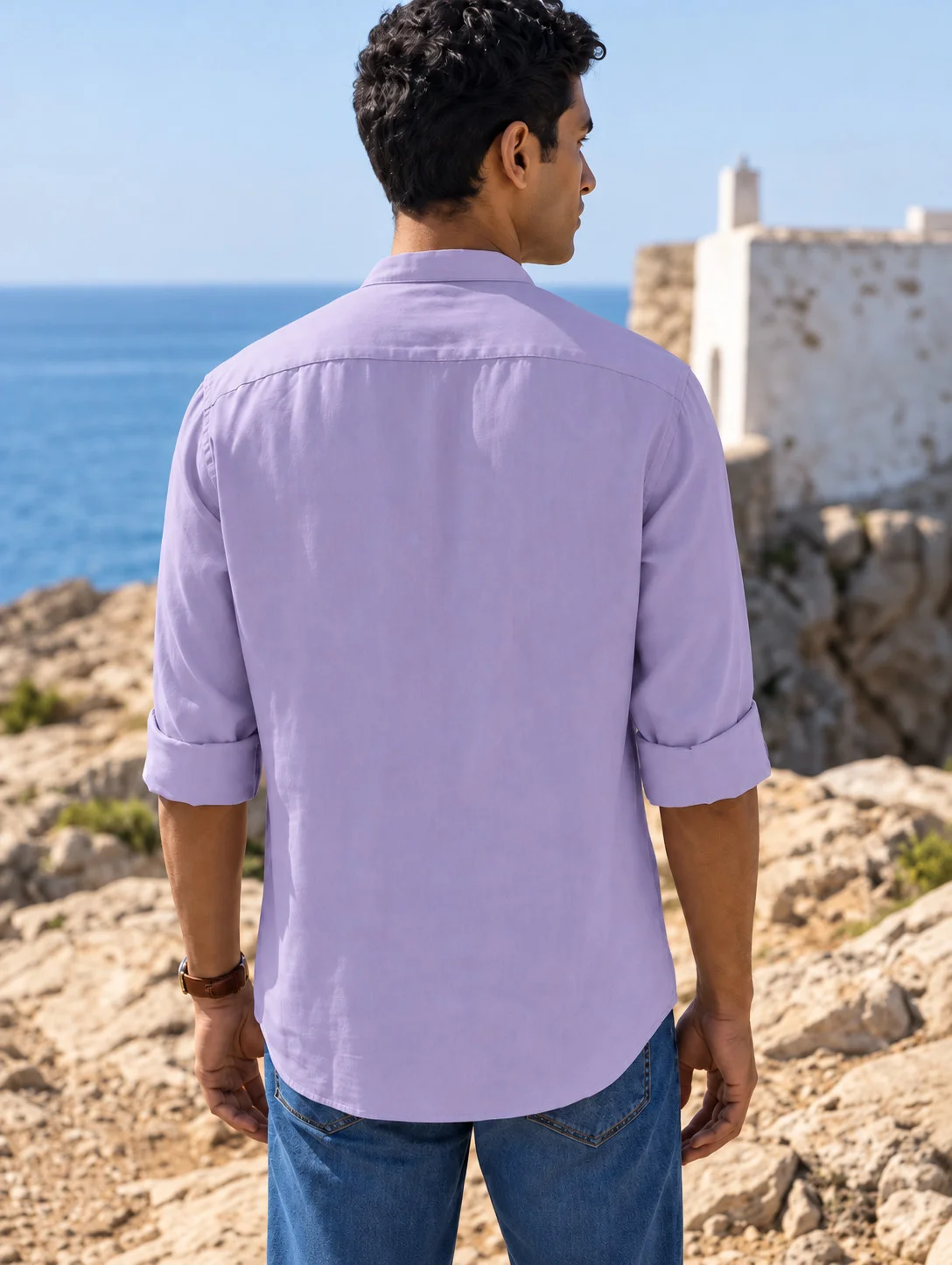 Model seen from behind wearing a purple shirt kurta with rolled-up sleeves and blue jeans