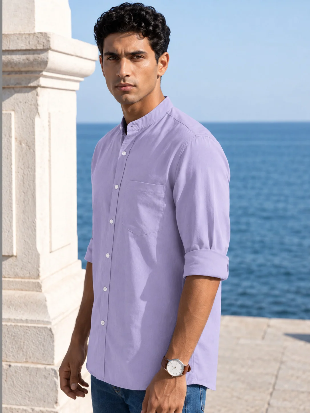 A model wearing a purple short kurta with a mandarin collar, chest pocket, and rolled-up long sleeves, front view
