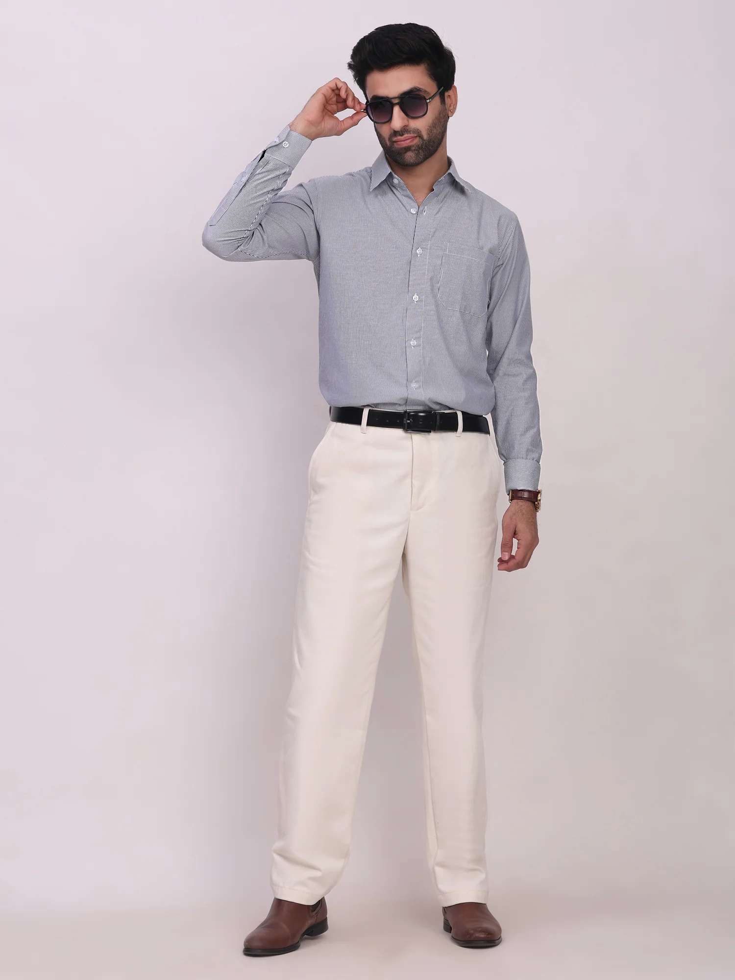Long sleeved shirt, light blue colour, worn by a model, buttoned collar, cuffs, buttons down front