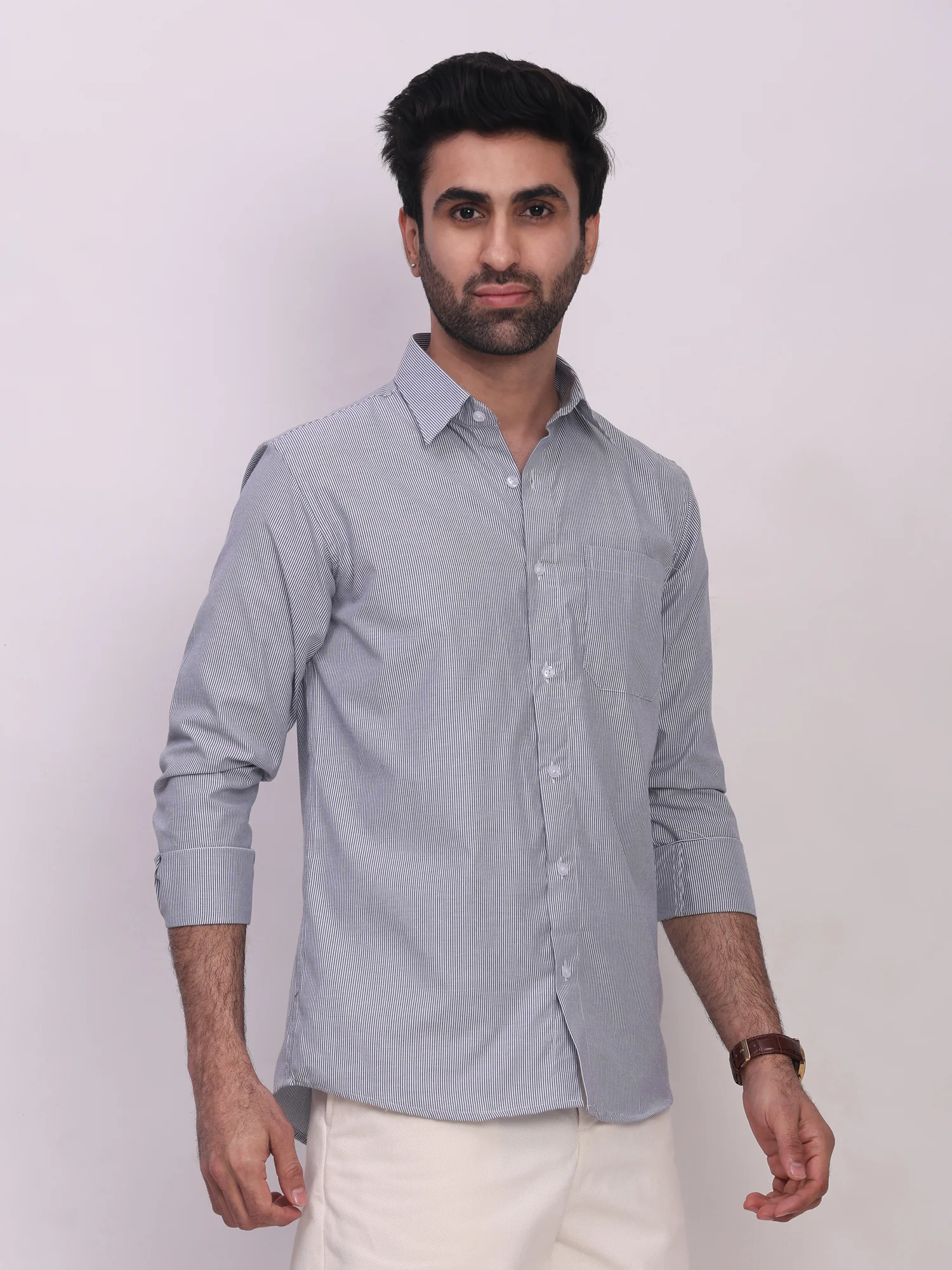 Long sleeved blue striped shirt, front view, worn by a model, collar, buttons